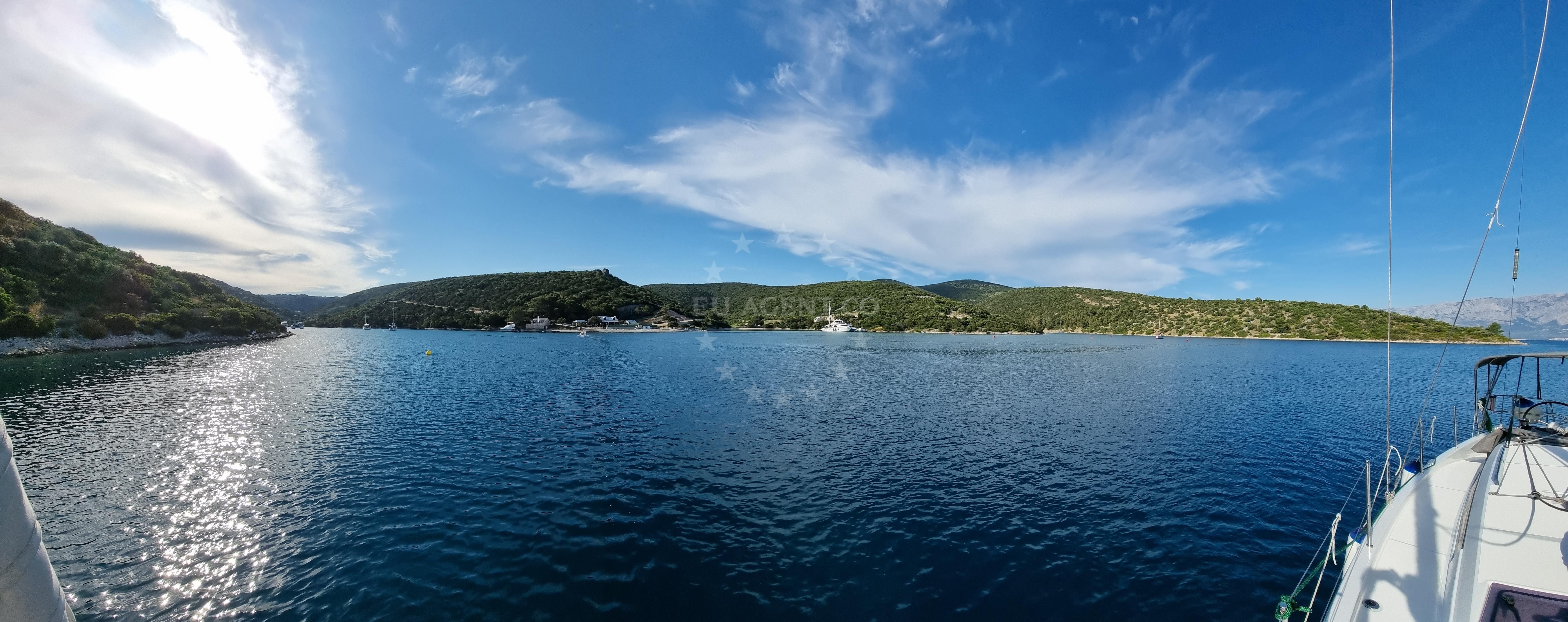 Tri luke anchorage in Povlja, Brac with boats moored nearby