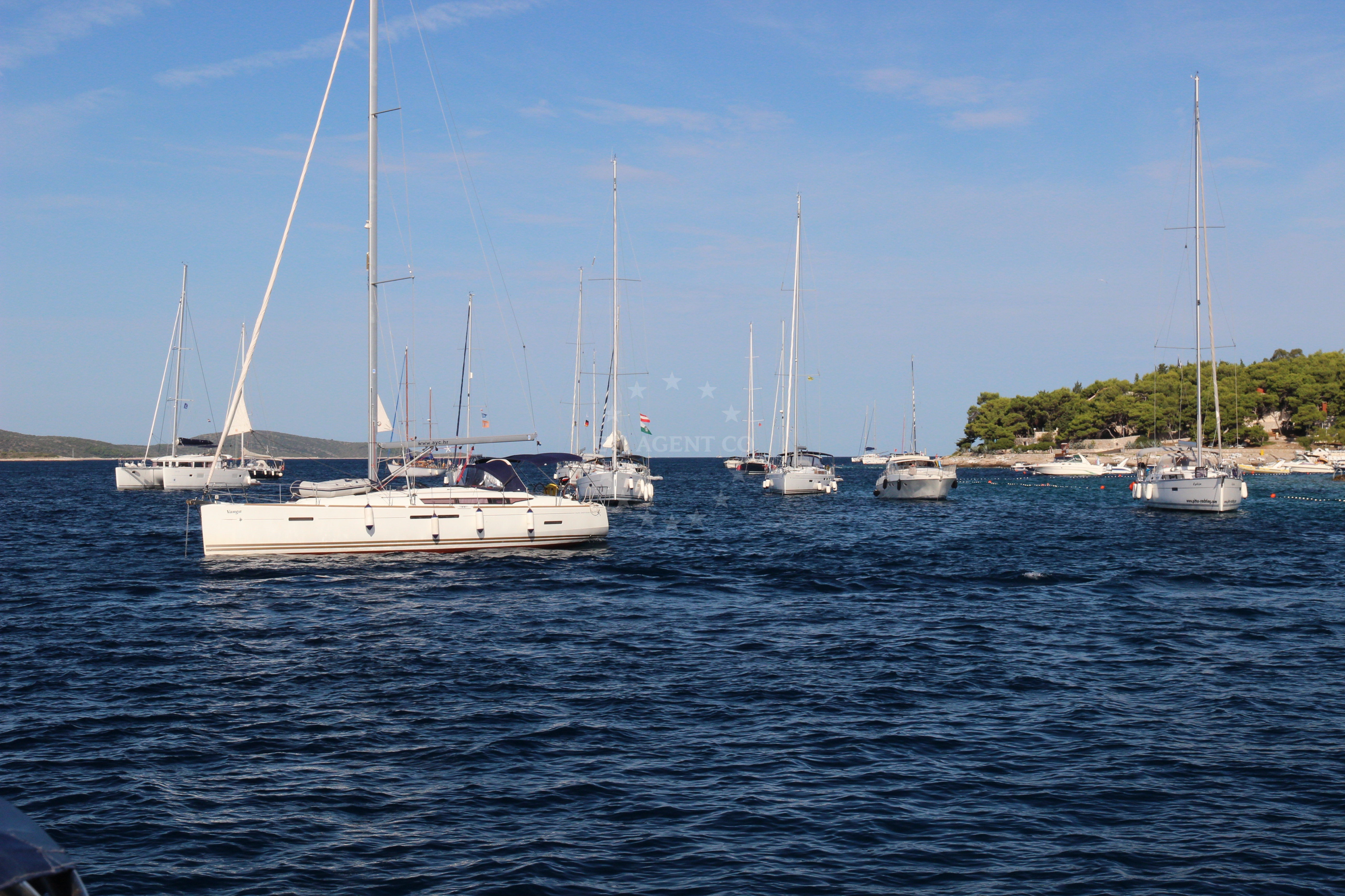 Shoreline view of Hvar Island anchorage with nearby buoys
