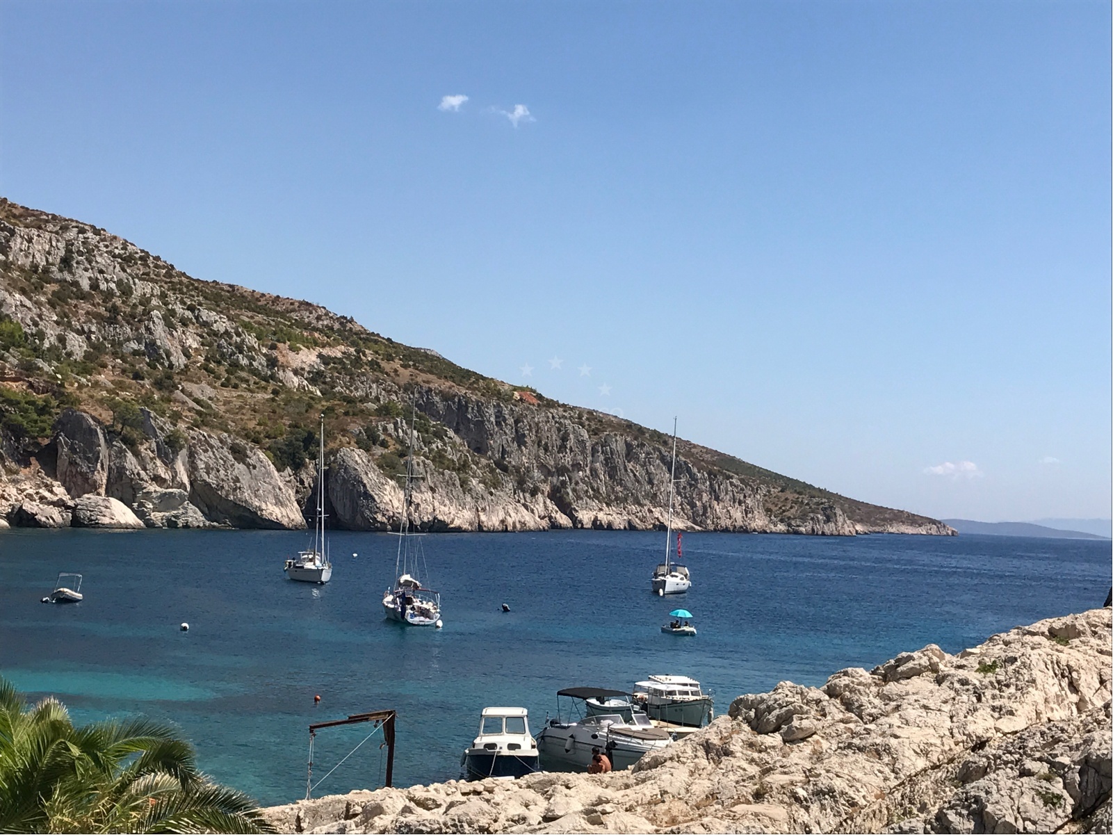 View of Hvar coastline from Zarace Anchorage with nearby yachts anchored