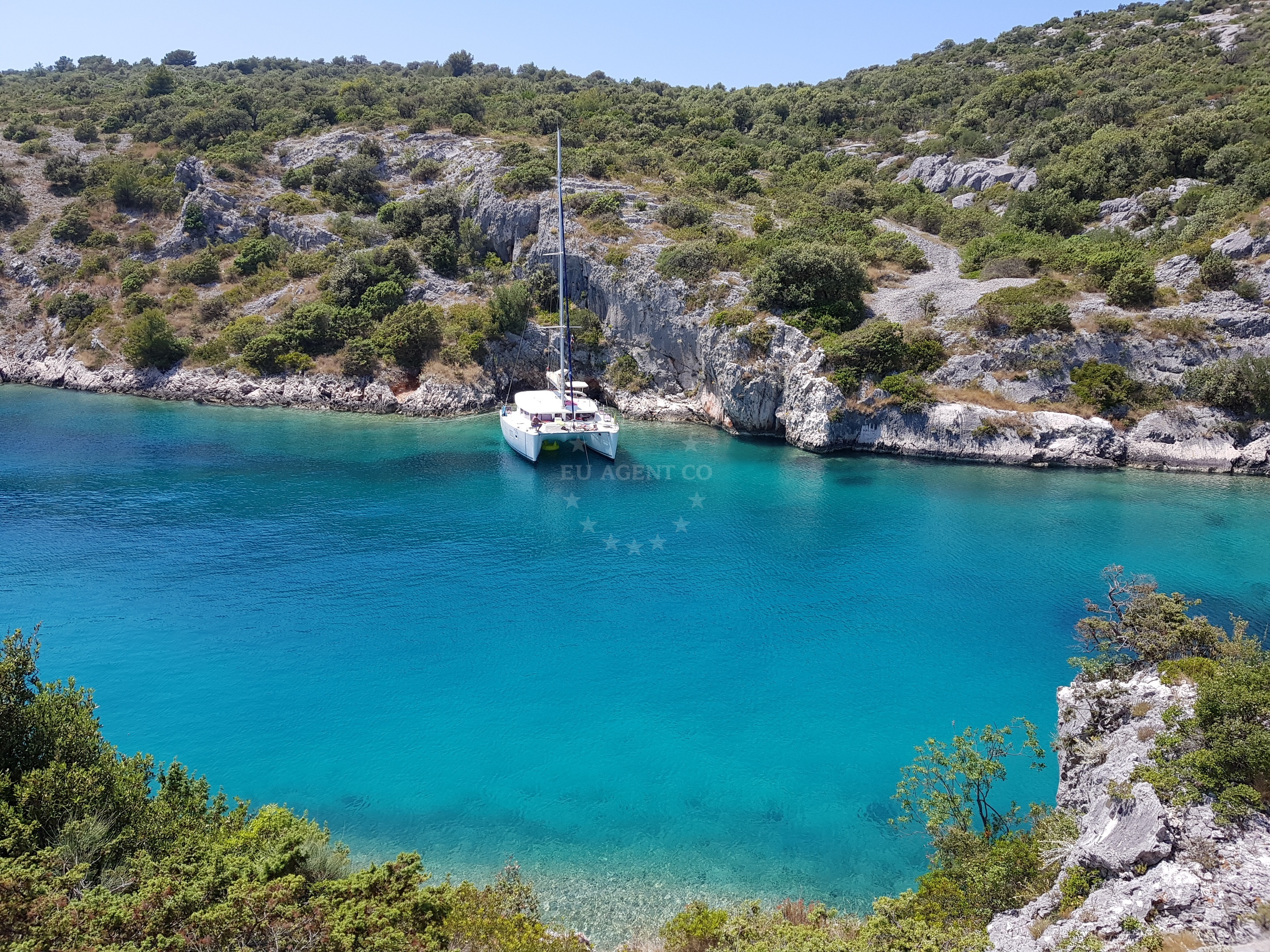 Boat anchored in Borovica with distant views of the Adriatic