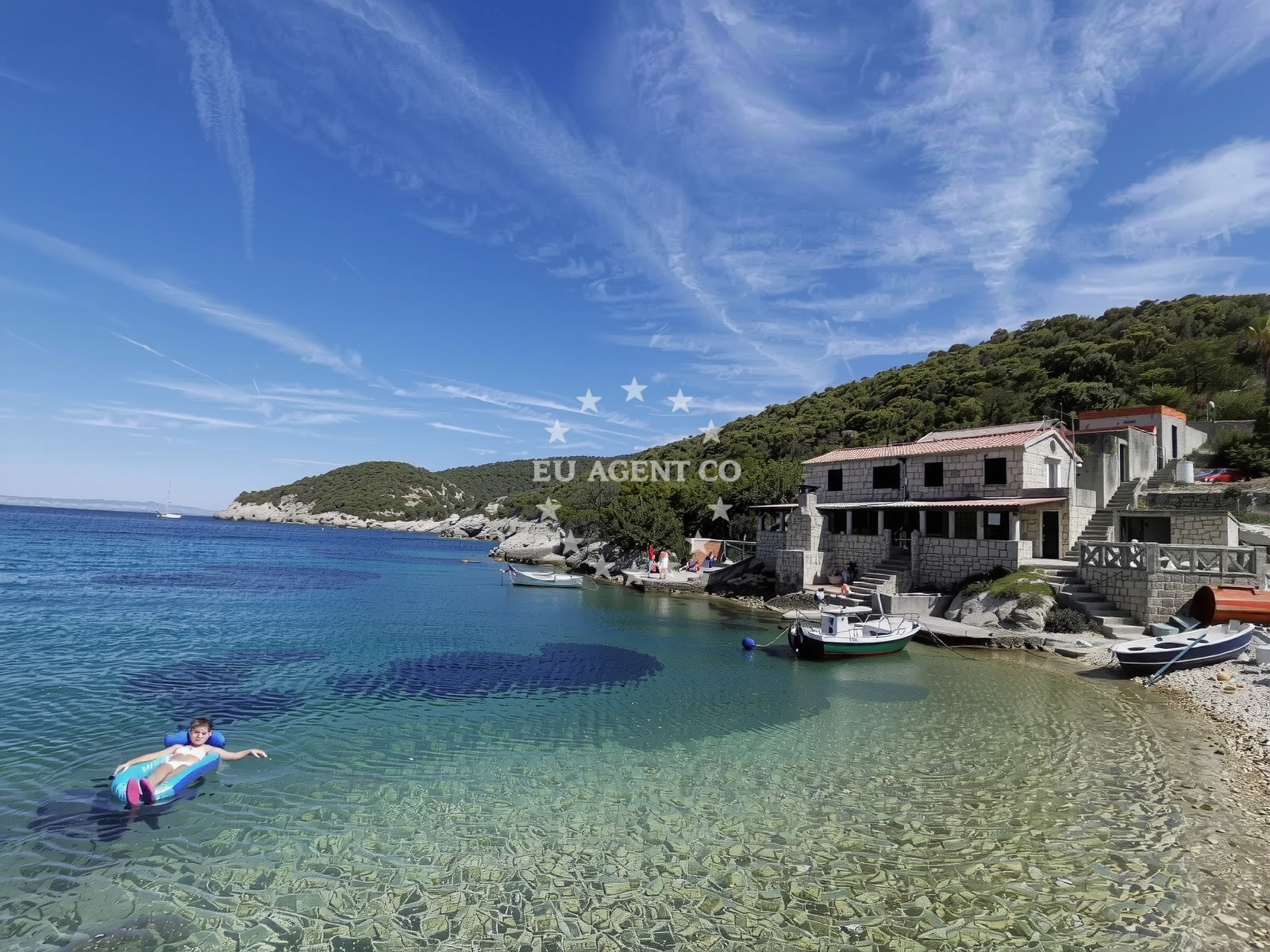 Anchorage in Komiza, Vis, Croatia with calm waters and nearby Okljucina village