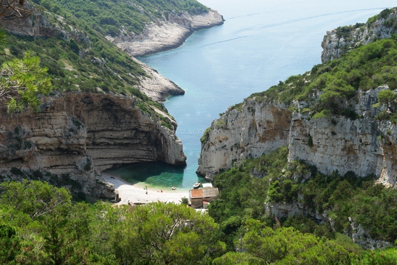 Stiniva Anchorage on Vis Island, Croatia, with calm waters and nearby shoreline