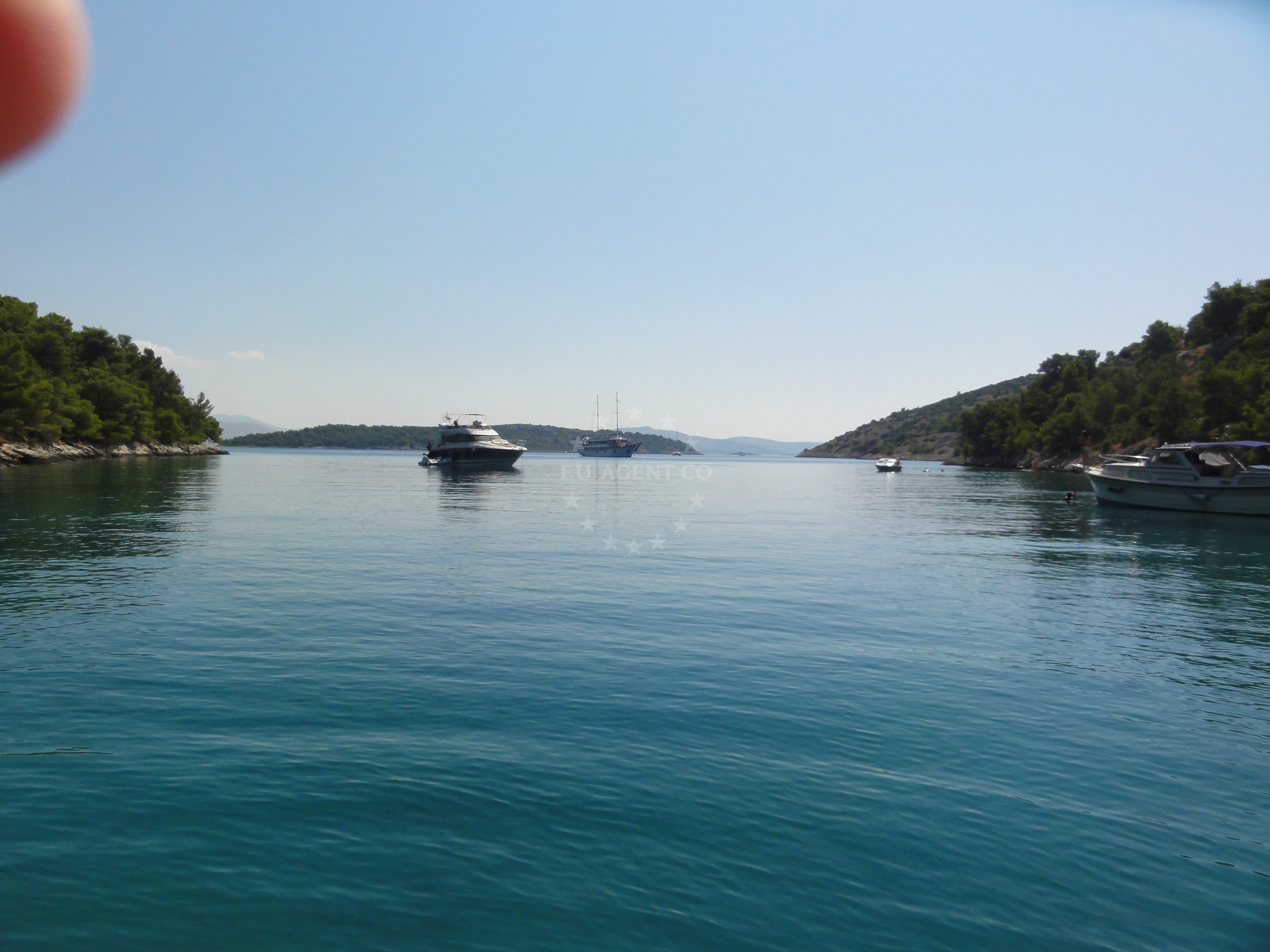 Yacht anchored near Zlarin Island with rocky outcrops in the background