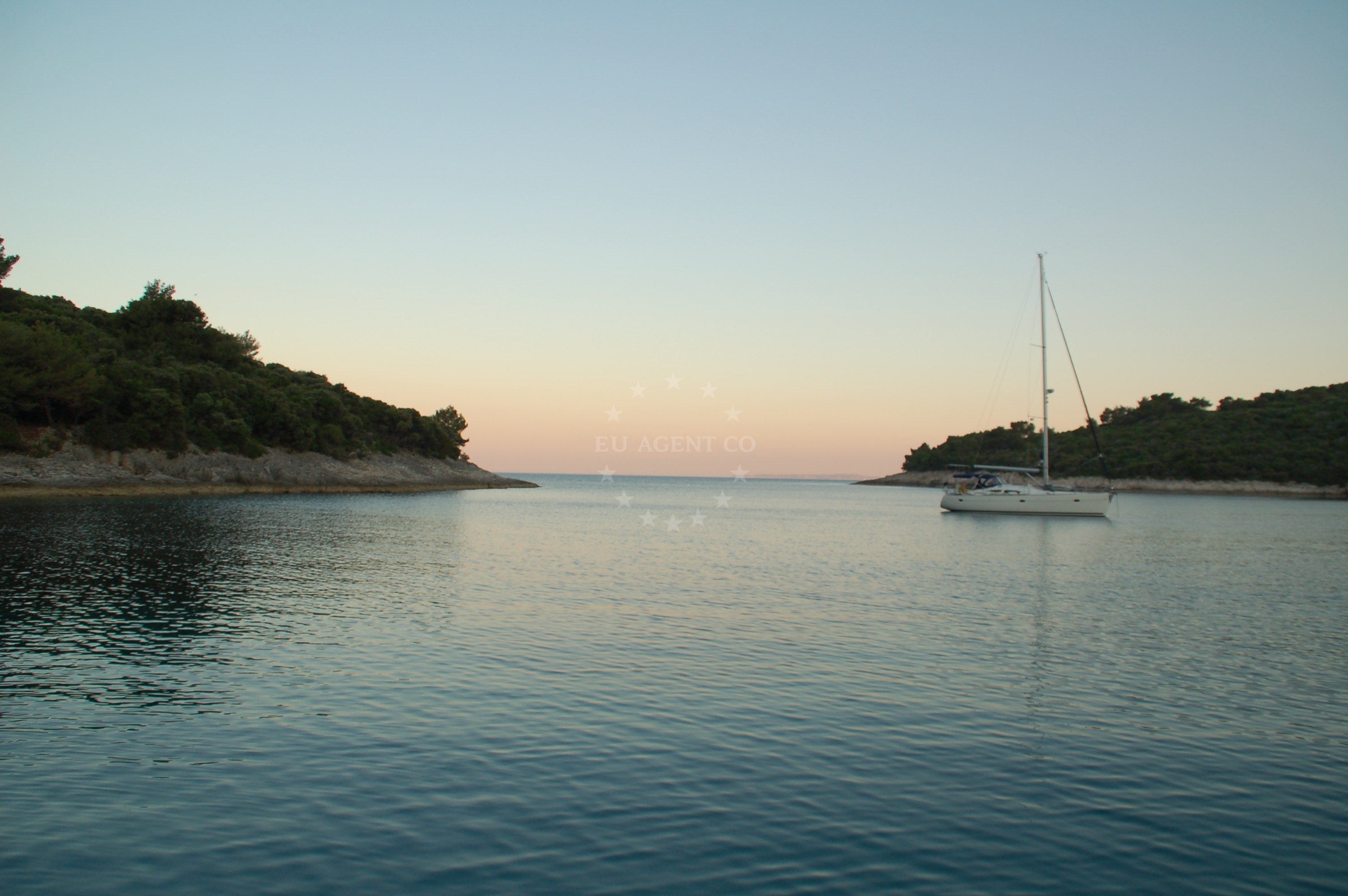 Anchorage view from the shore, showing the sandy seabed and nearby buoy field
