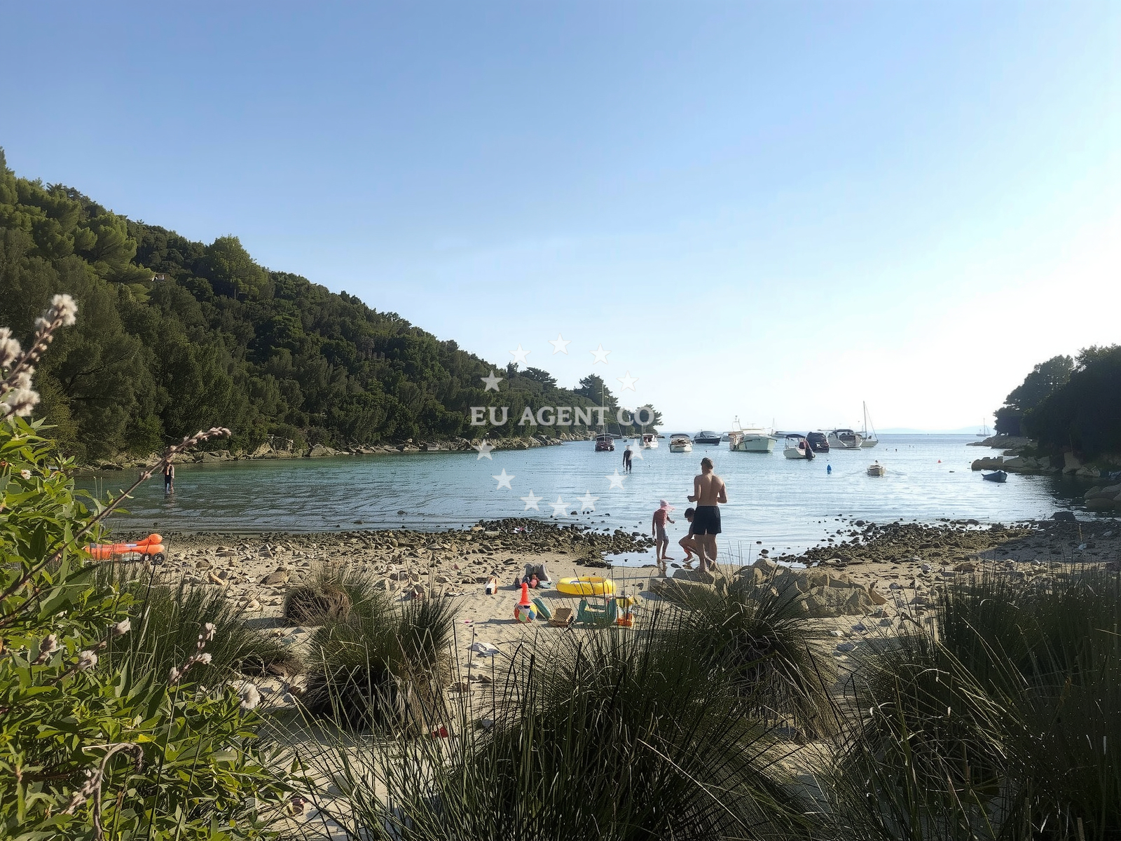 Busy summer anchorage on Rab Island with yachts and swimmers nearby