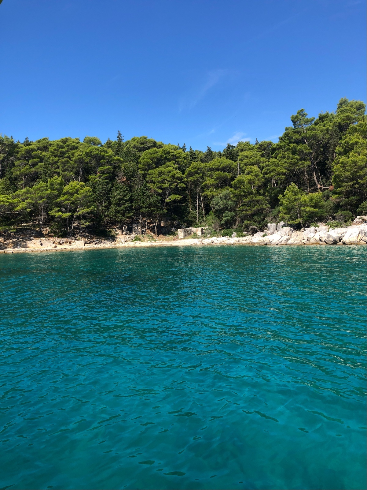 View of Rab Island anchorage with boats moored and coastal scenery