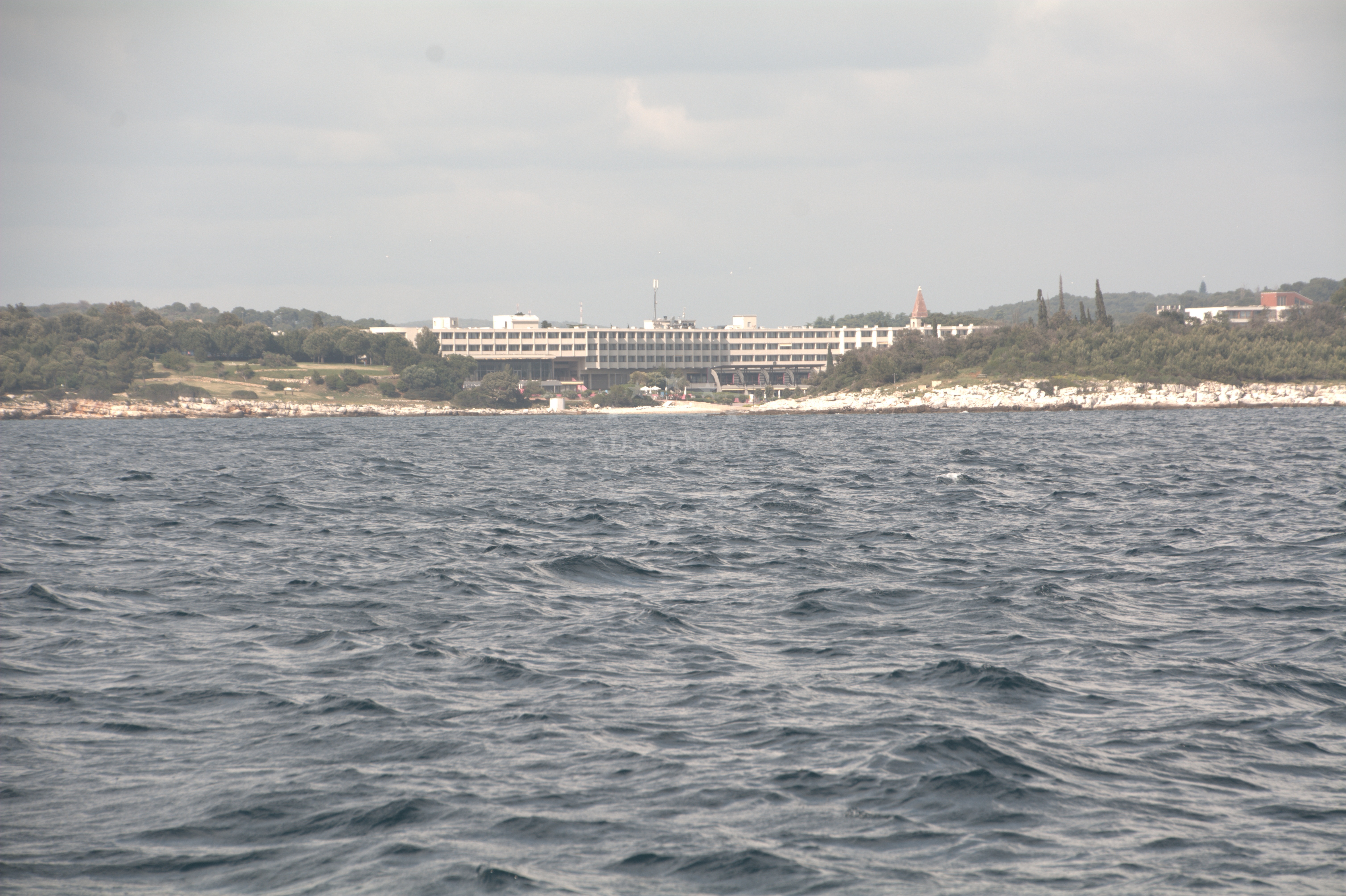 Sveti Andrija anchorage with calm waters and nearby island silhouette
