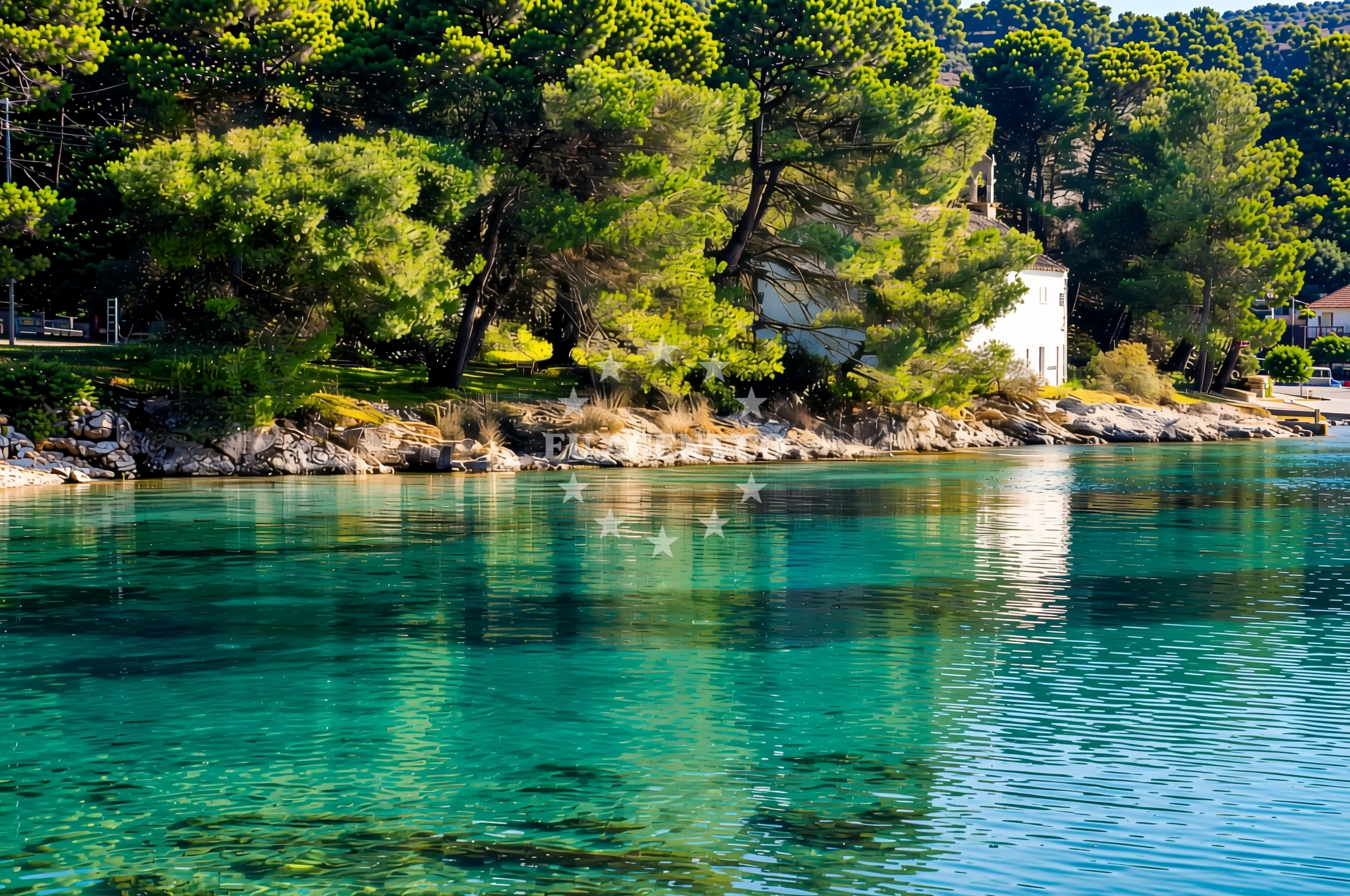 Yacht anchored at Grujica Island, North Dalmatia, with Ilovik village in the distance