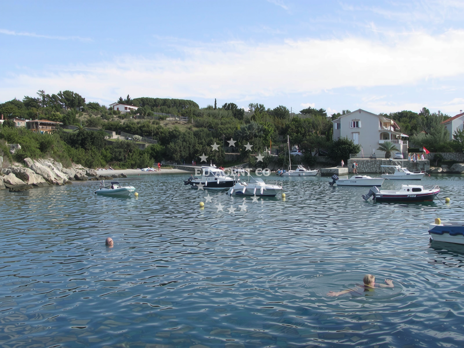 Anchorage in Potočnica, Pag, Croatia with a yacht moored near the shore
