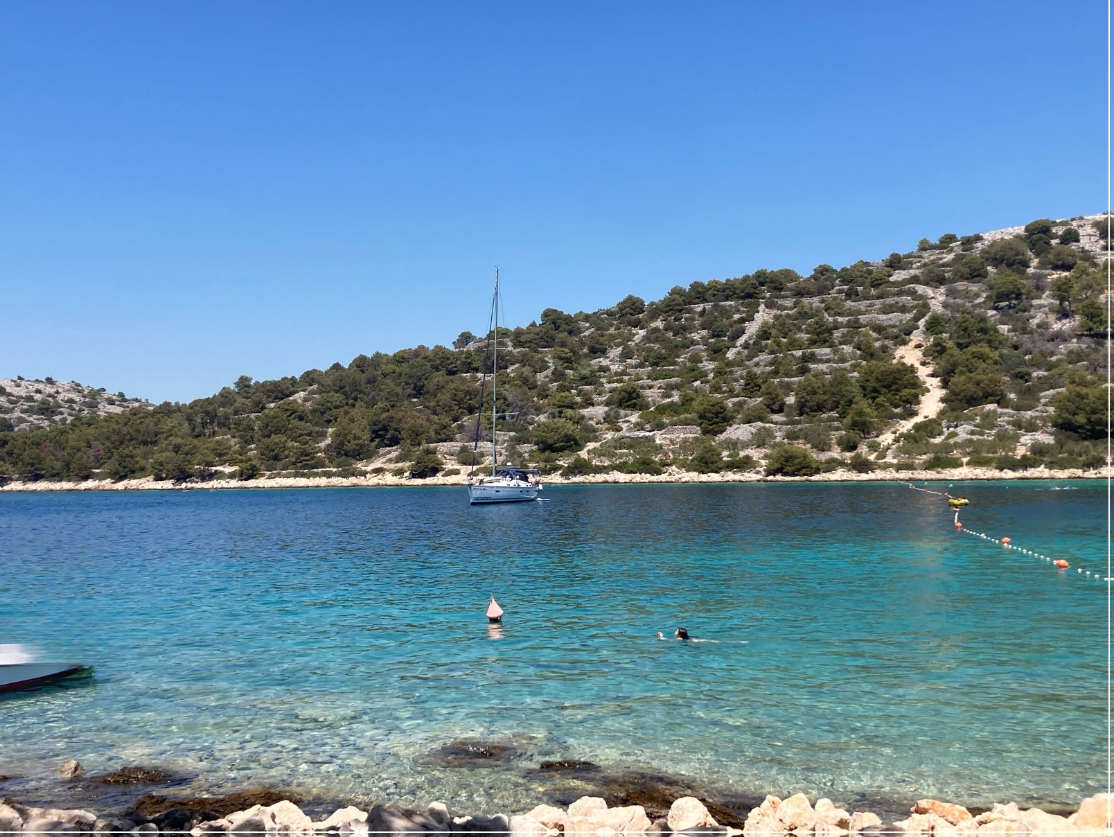 Anchorage on Skojic Island, North Dalmatia, Croatia with views of the surrounding coastline and nearby village of Podvrske