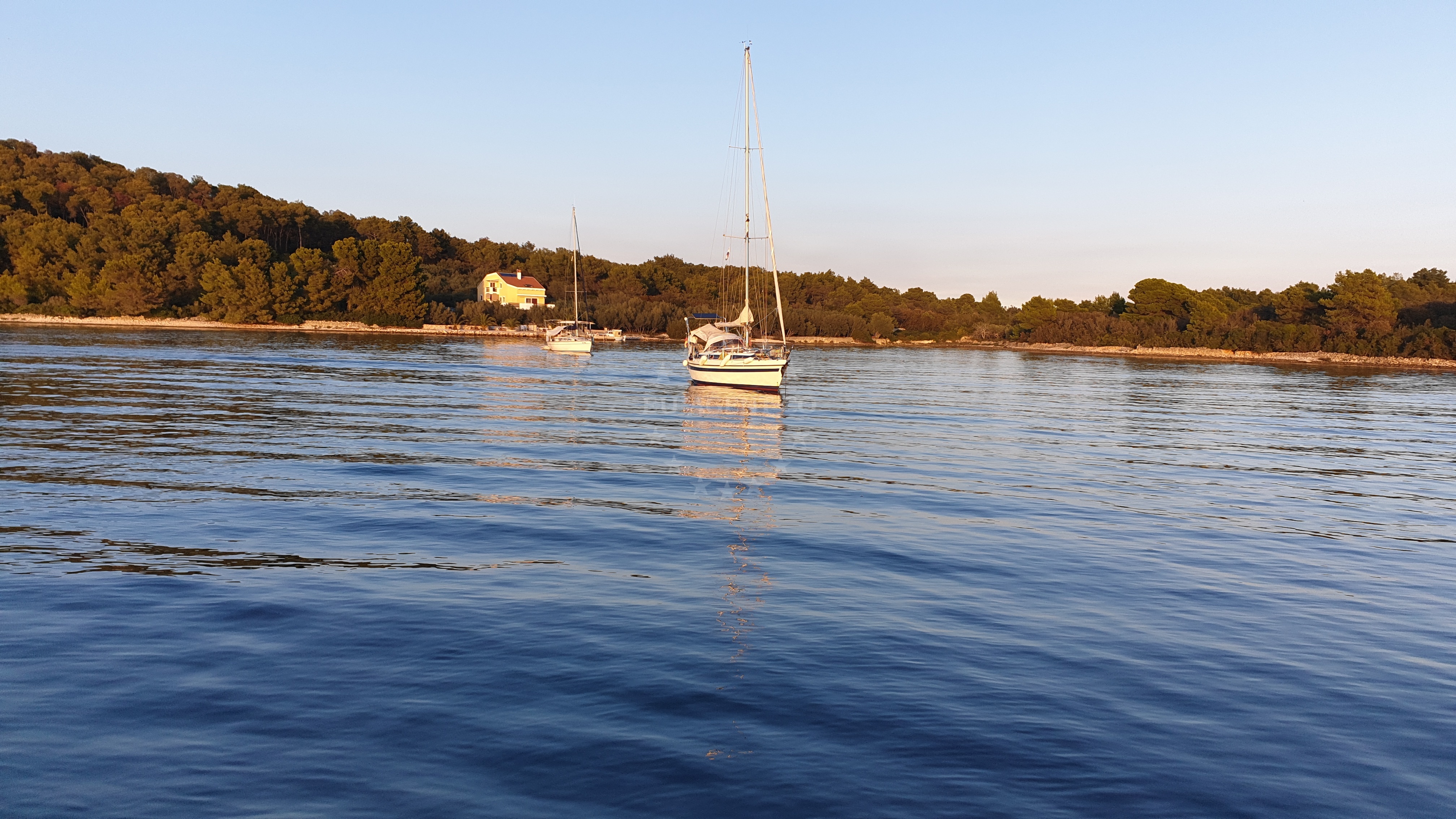 Anchorage in Kukljica, Ugljan, North Dalmatia, Croatia with sandy seabed and nearby coastal landscape