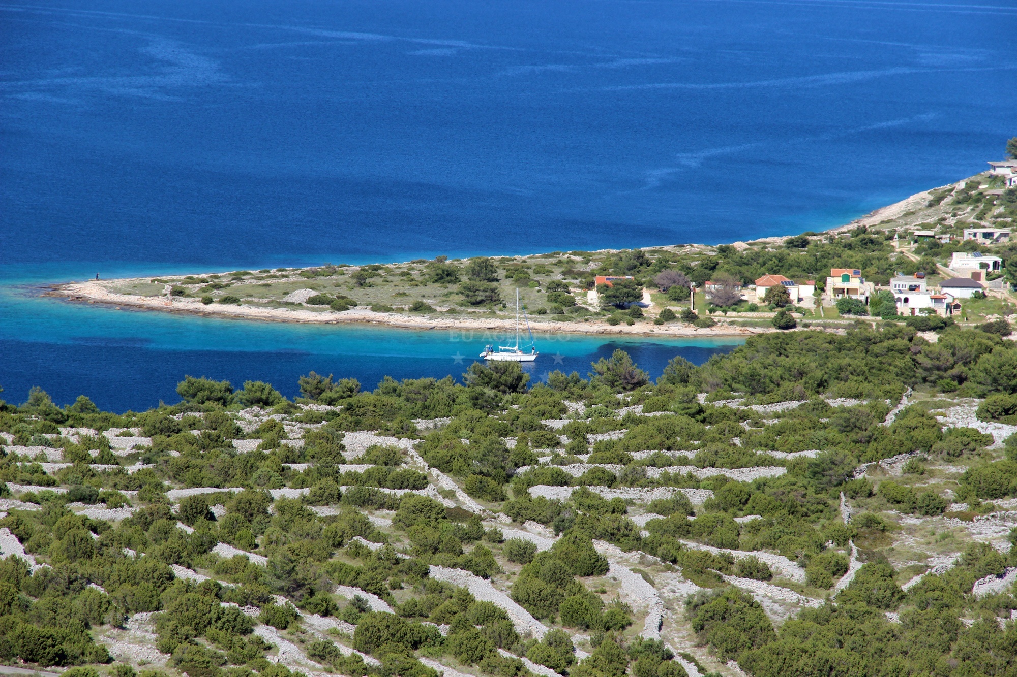 Anchorage on Žirje Island, North Dalmatia, Croatia with sandy seabed and view of Mikavica