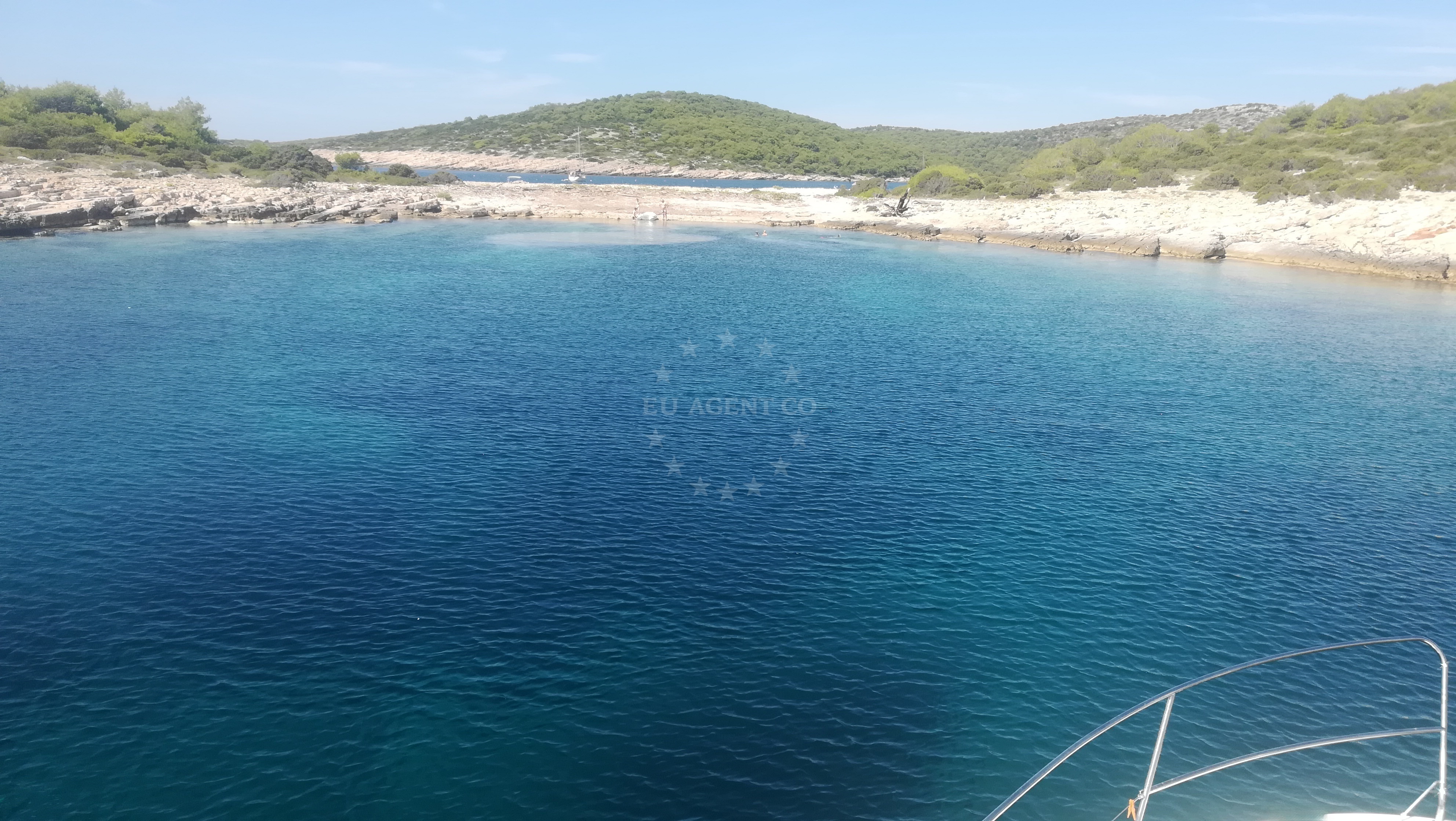 Boat anchoring at Zirje Island, North Dalmatia, Croatia near coastal rock formations