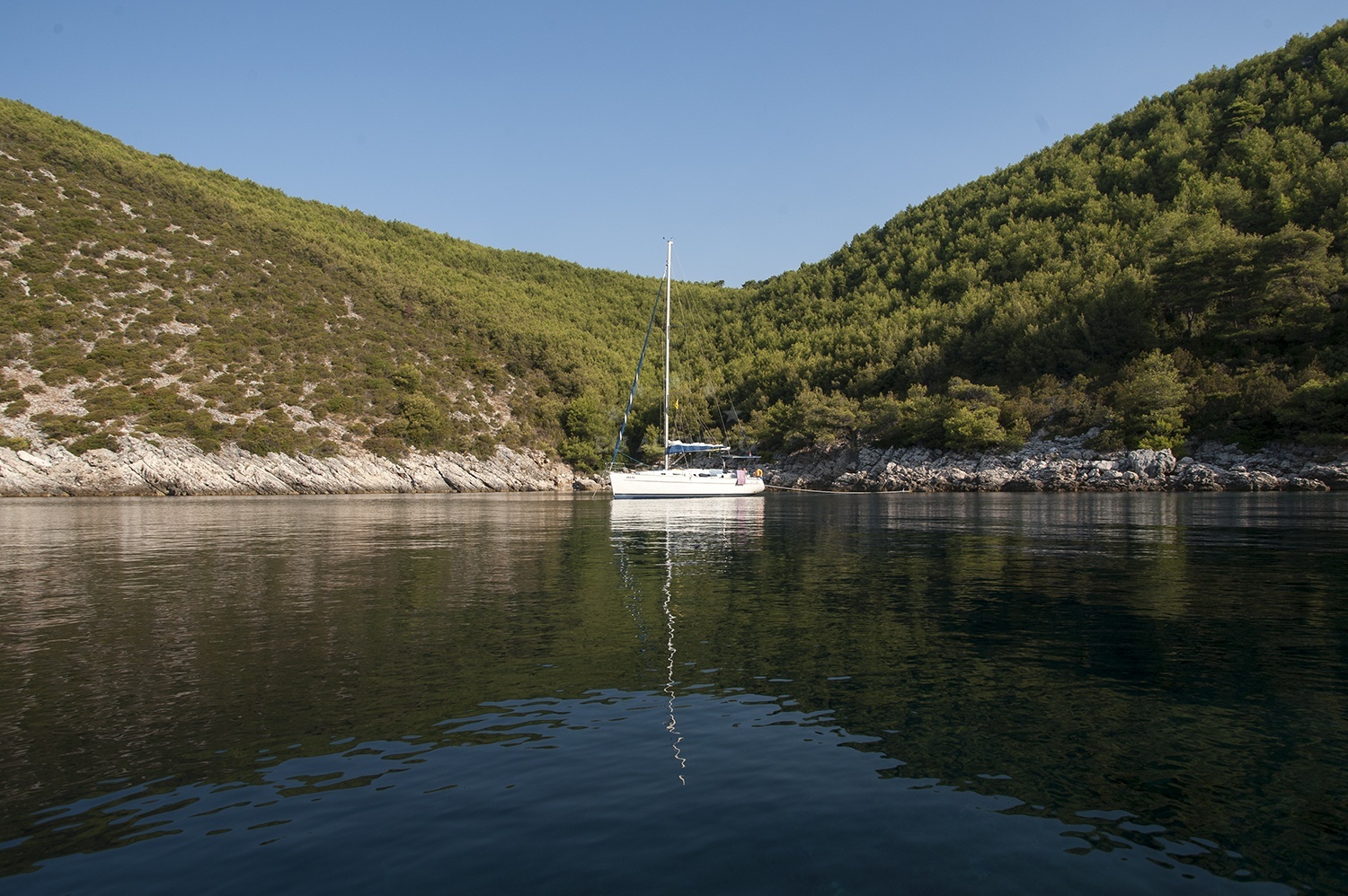 Ribnja Anchorage in Broce, Croatia: calm waters surrounded by untouched natural landscape with distant hills.