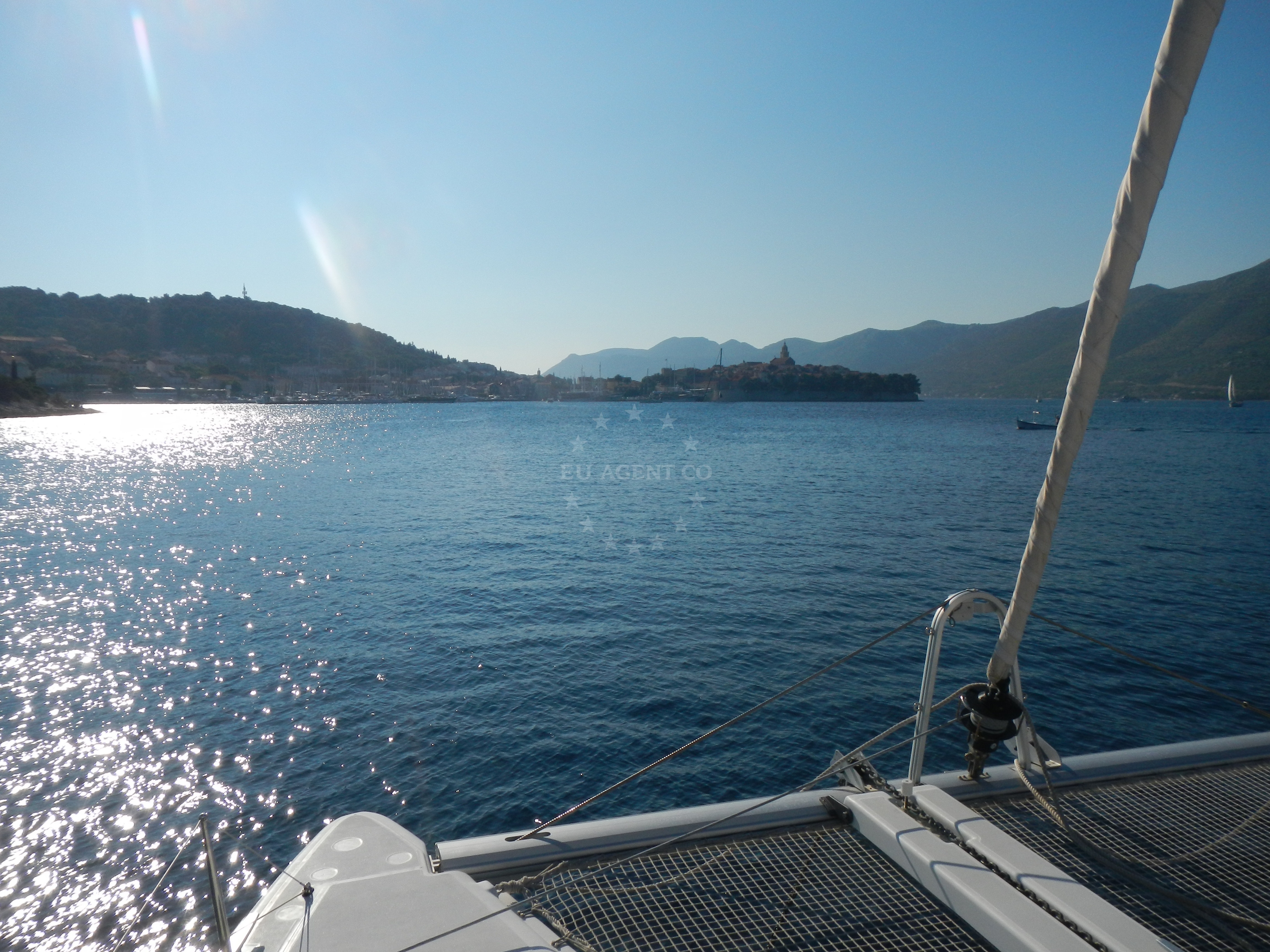 Boat anchoring at Korcula, Croatia with nearby coastline
