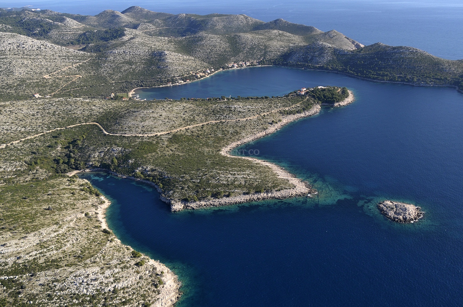 Anchorage on Lastovo Island with calm waters and nearby Uska village in the distance
