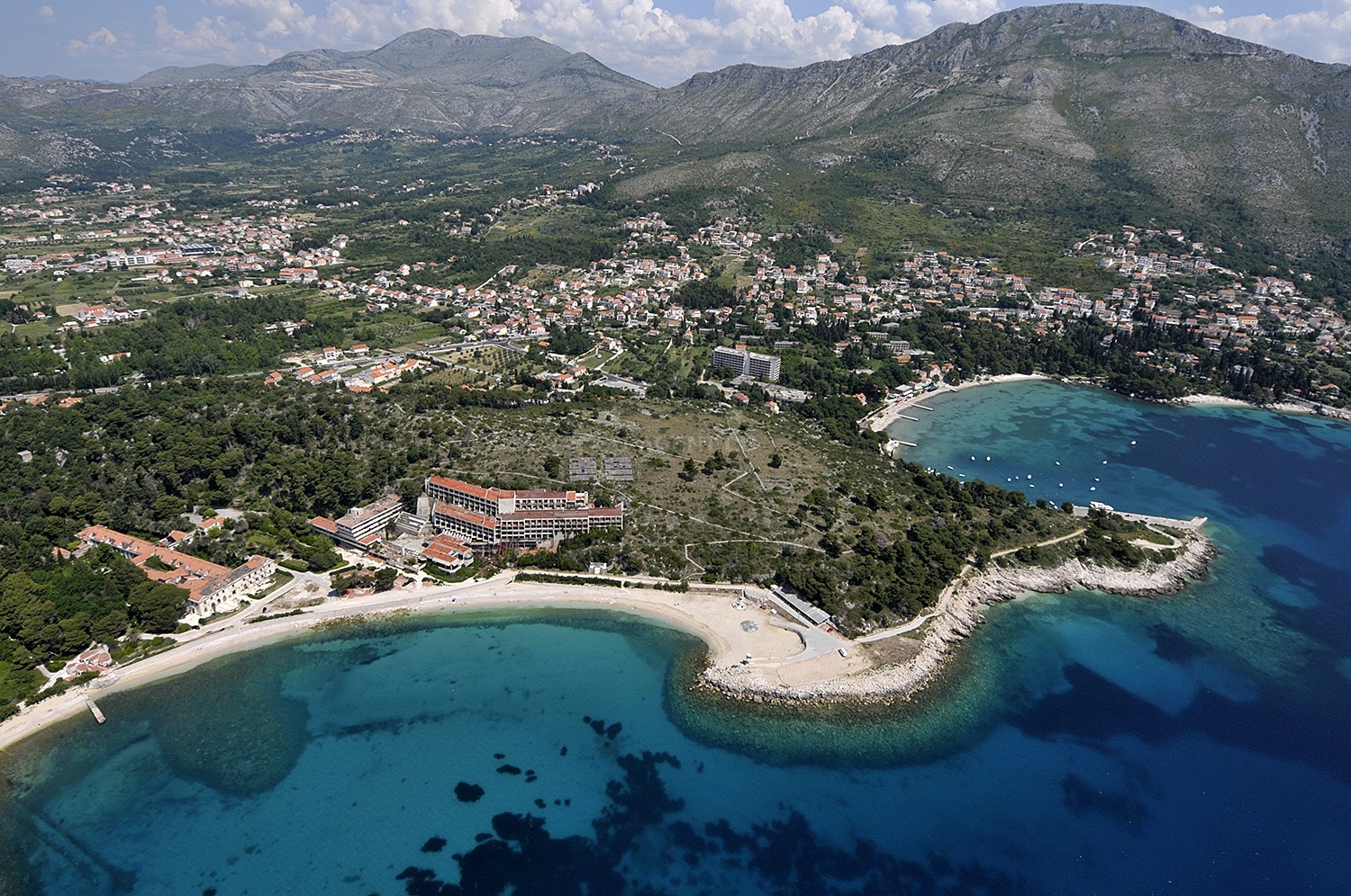 Boat anchored at Srebreno with nearby Mlini Beach in the distance