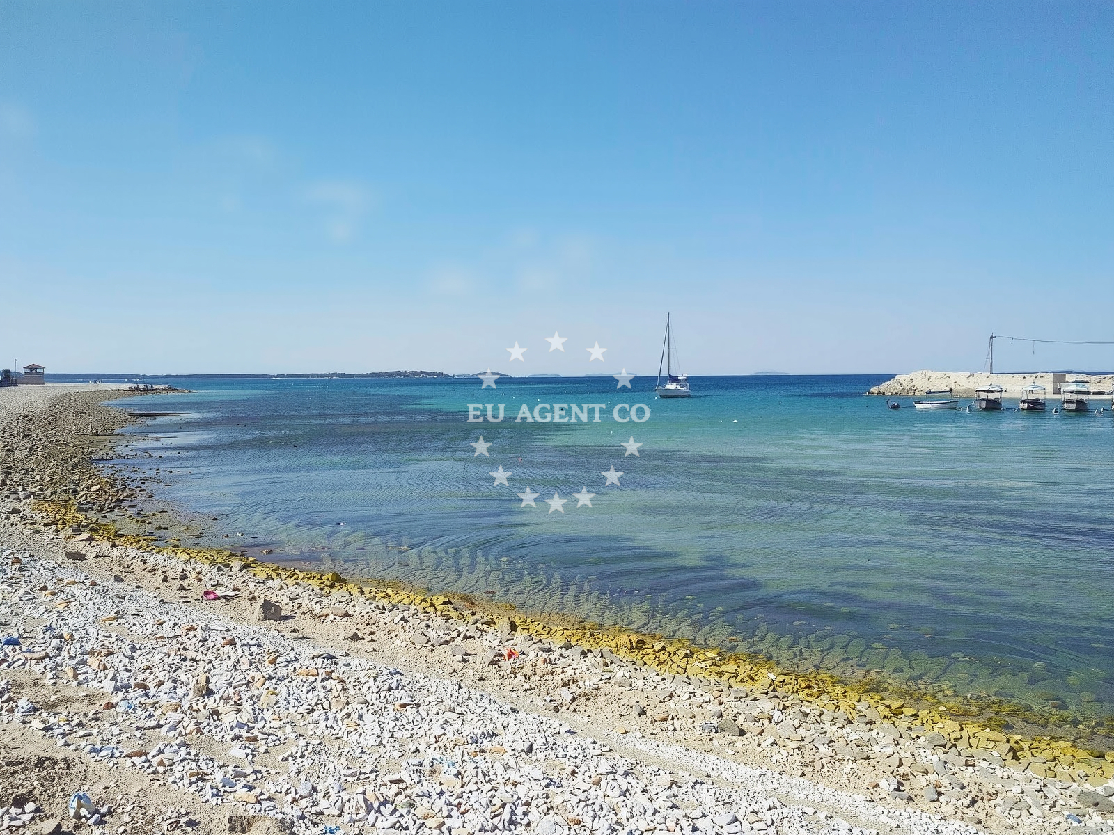 Shoreline and swimming area at Portic beach in , Peroj