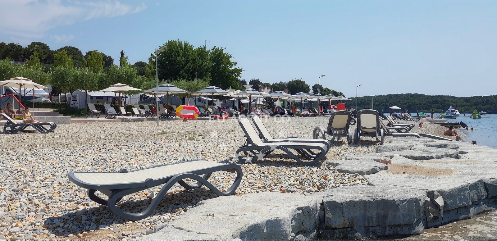 Shoreline and swimming area at Val Saline beach in Monsena 1, Rovinj
