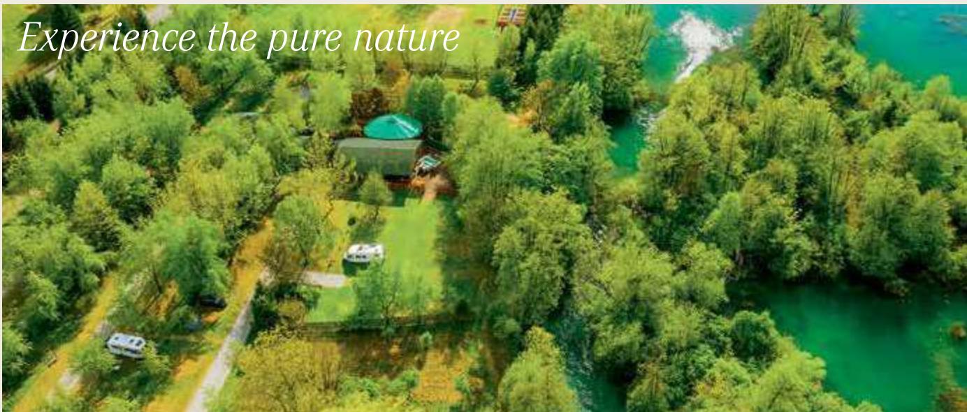 Camping area by the Mrežnica River with islets, waterfalls, and family-friendly atmosphere.