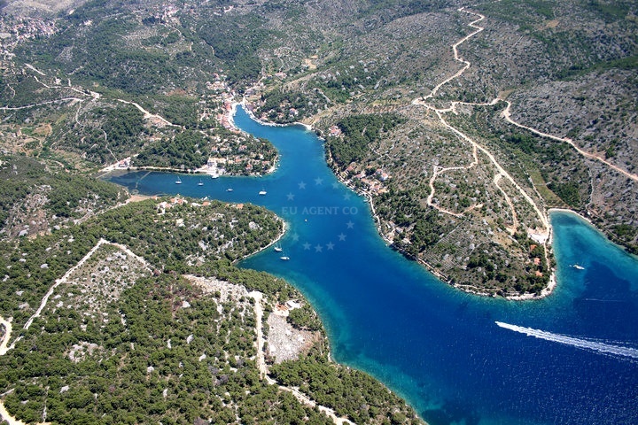 Clear waters of Bobovišća Bay with anchored yachts