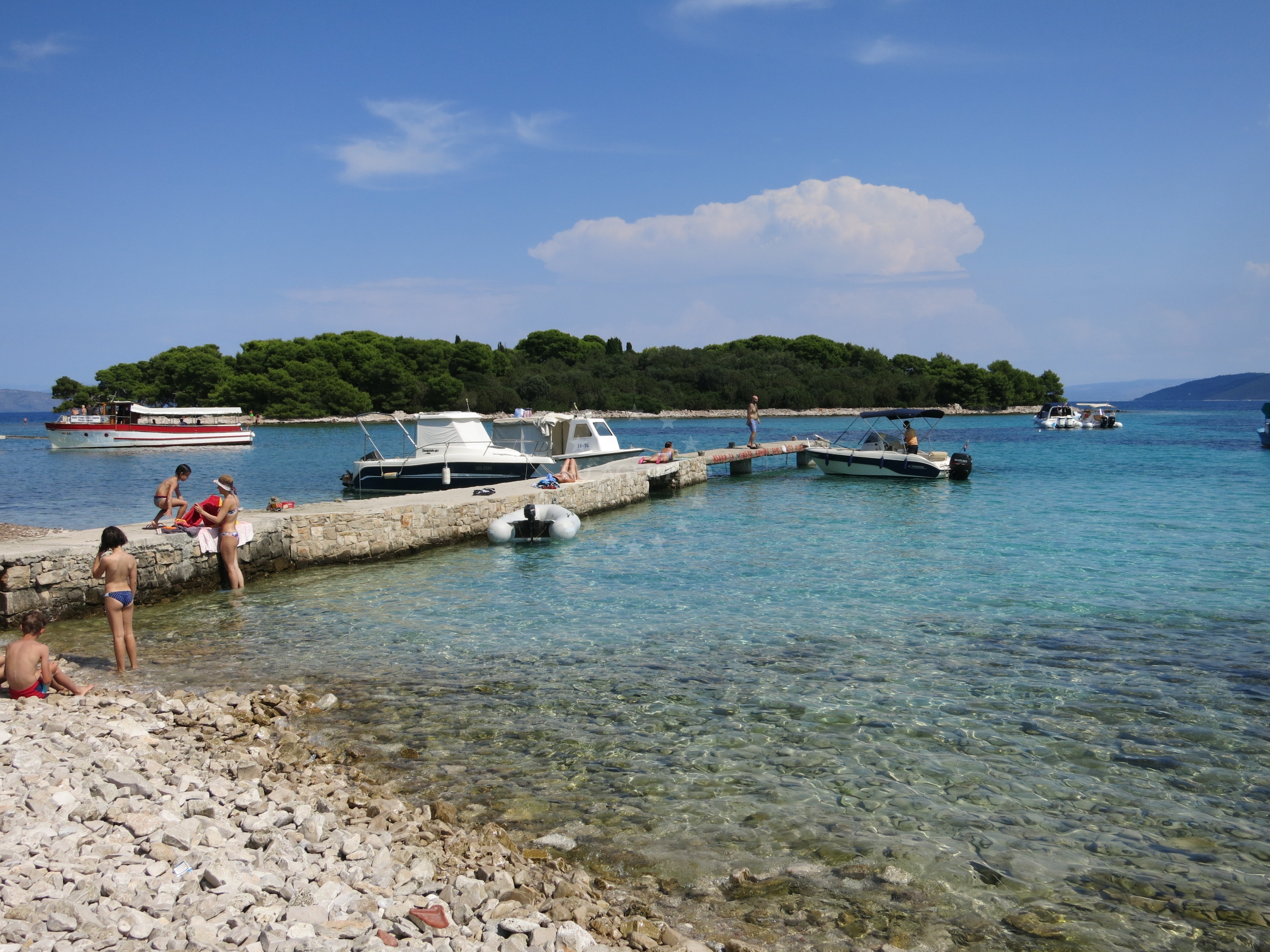 Jetty on Drvenik Veli Island with boats moored nearby