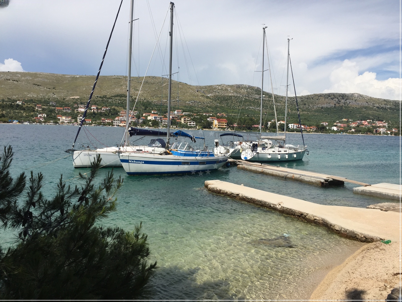 Jetty in Grebastica, Central Dalmatia, Croatia with yachts moored along the structure.