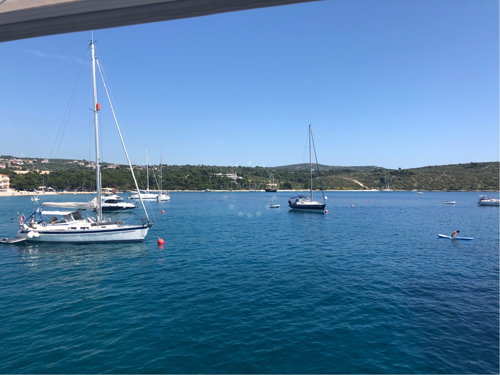 Sailor navigating buoy field in Primosten, Croatia