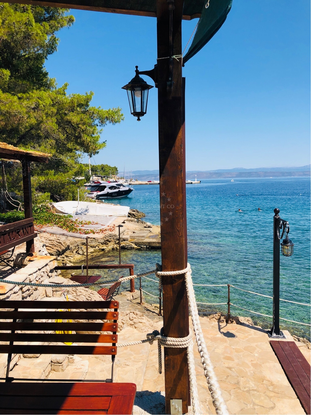 Pasarela Restaurant Jetty with nearby boats and scenic coastal backdrop