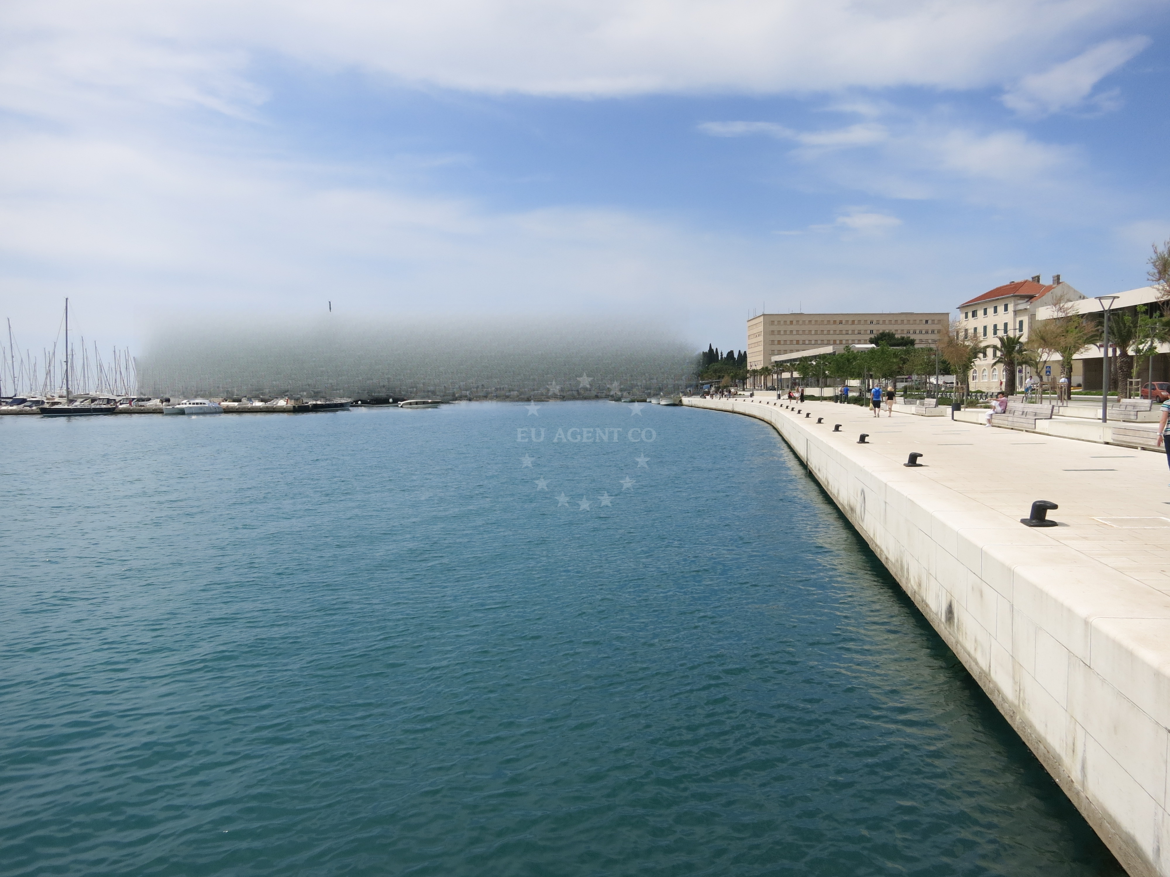 Modern quay structure in Split's central harbor with city skyline in the background