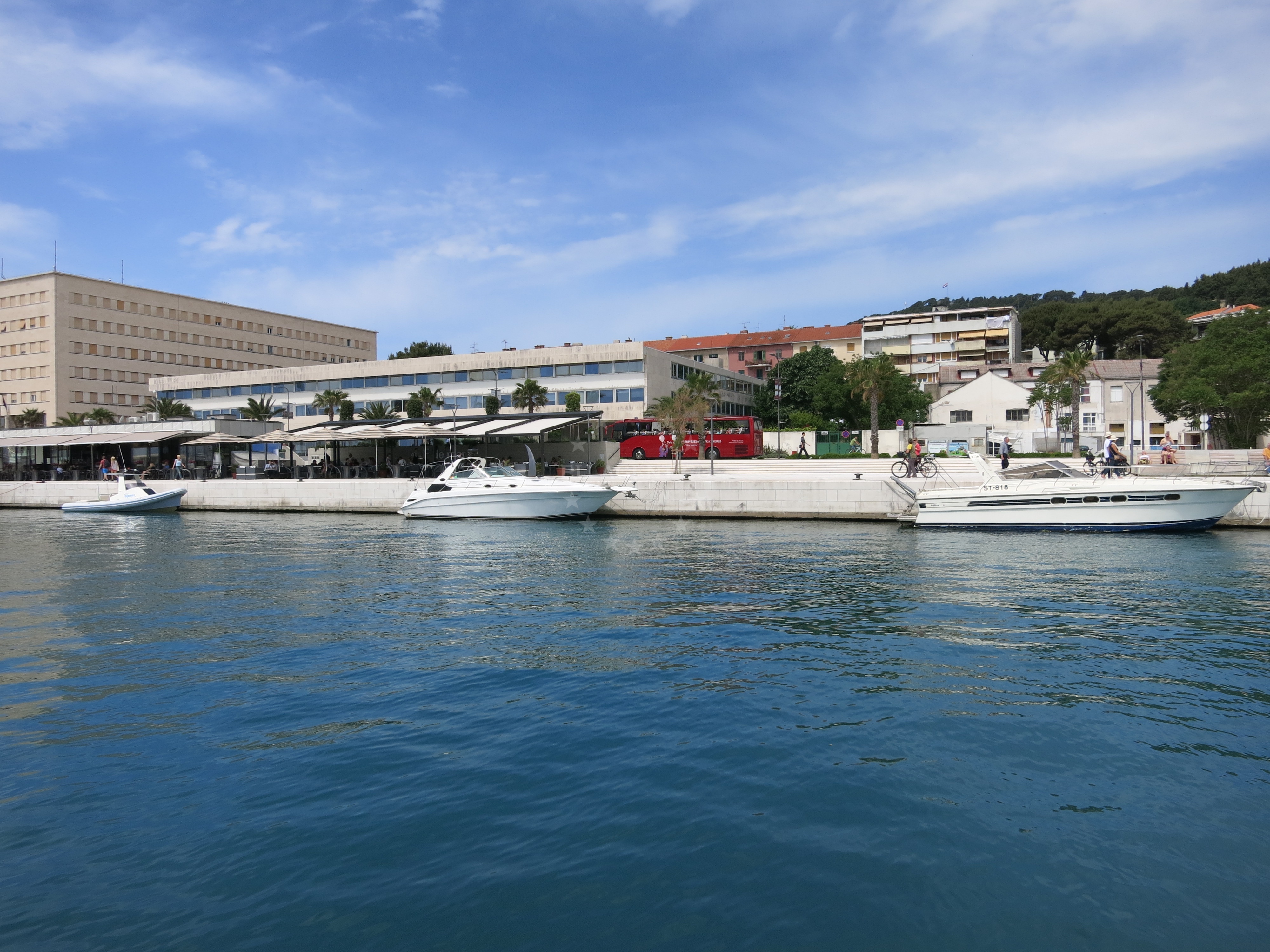 Close-up of quay's concrete structure with mooring lines and harbor views