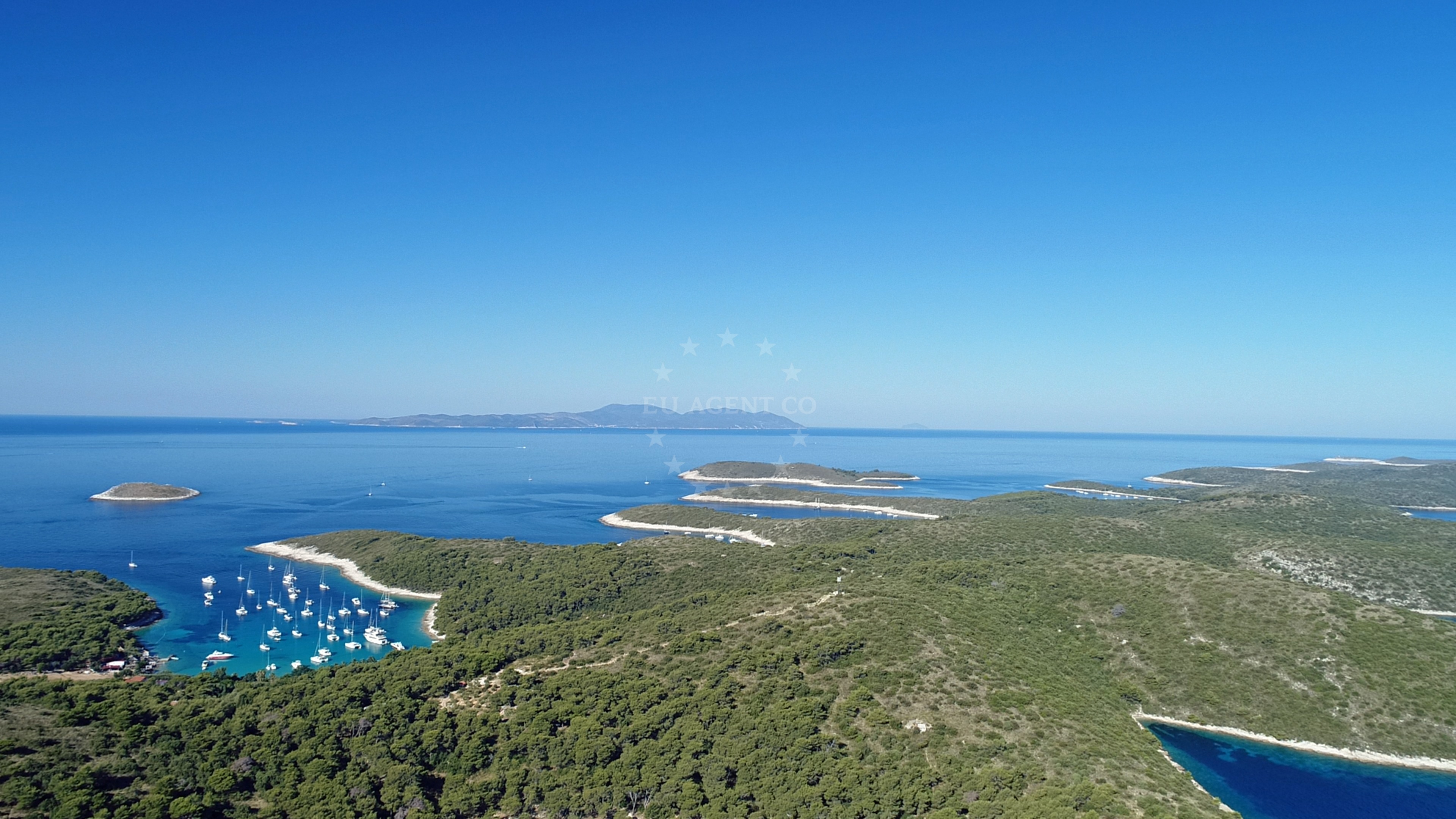 View of St. Klement Island with anchored boats near the buoy field