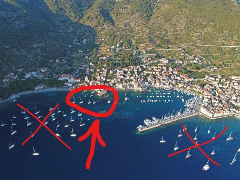 Komiza Buoy Field with yachts moored in sheltered waters near Vis, Croatia
