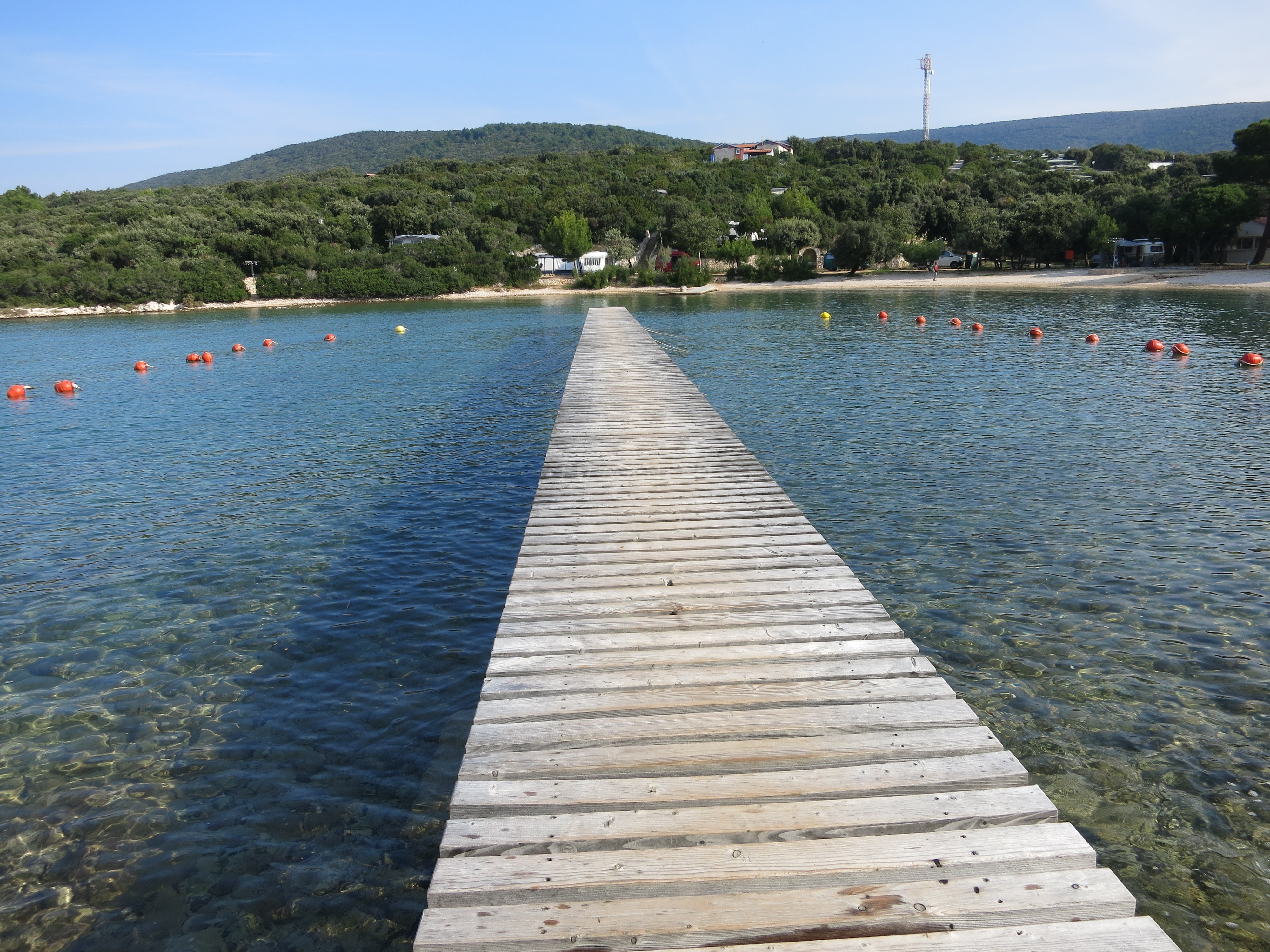 Shallow waters near Martinscica Jetty, Cres Island, Croatia with nearby beach access