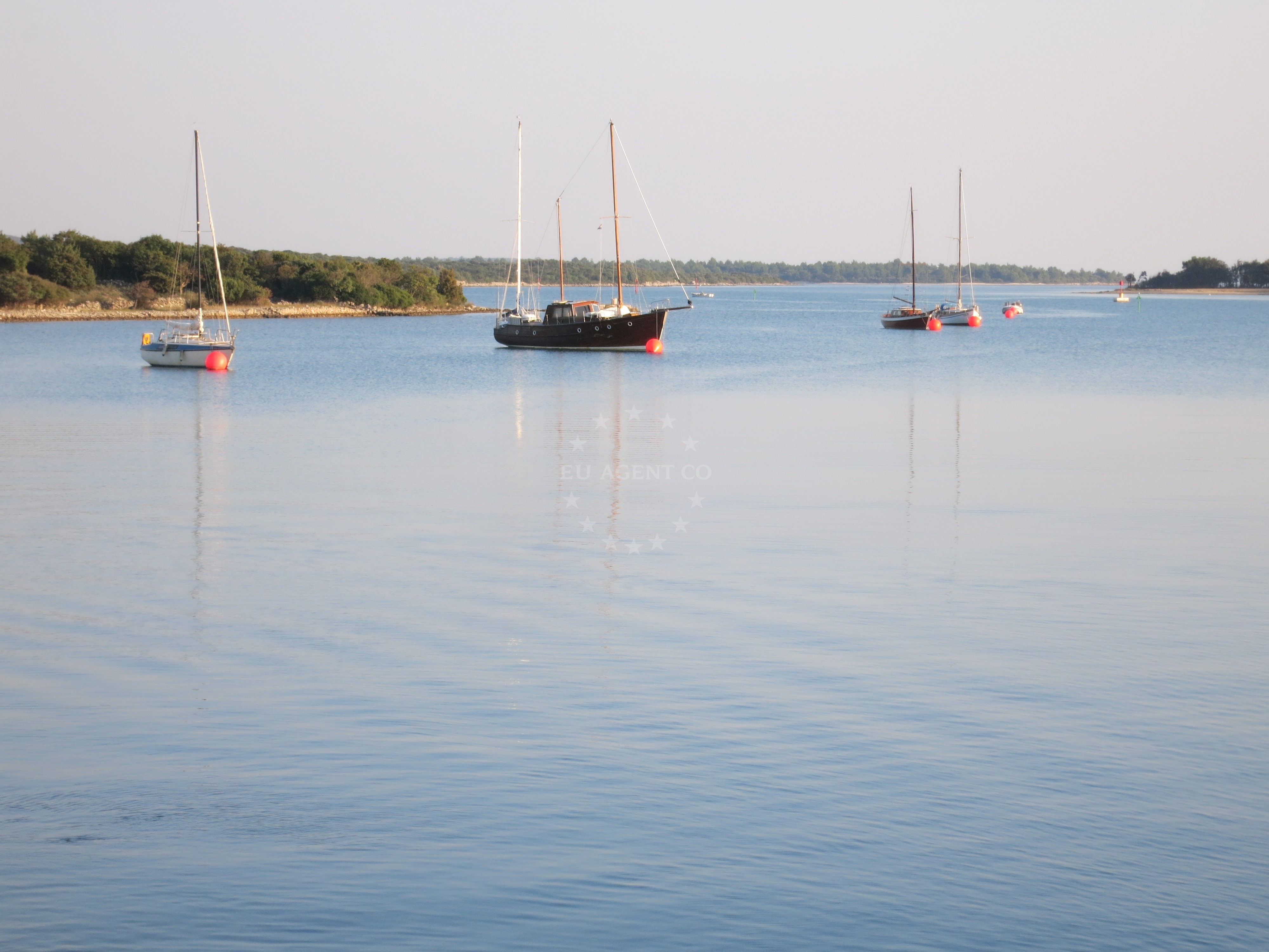 Jetty and buoy field near Osor, Cres, Croatia with boats anchored nearby