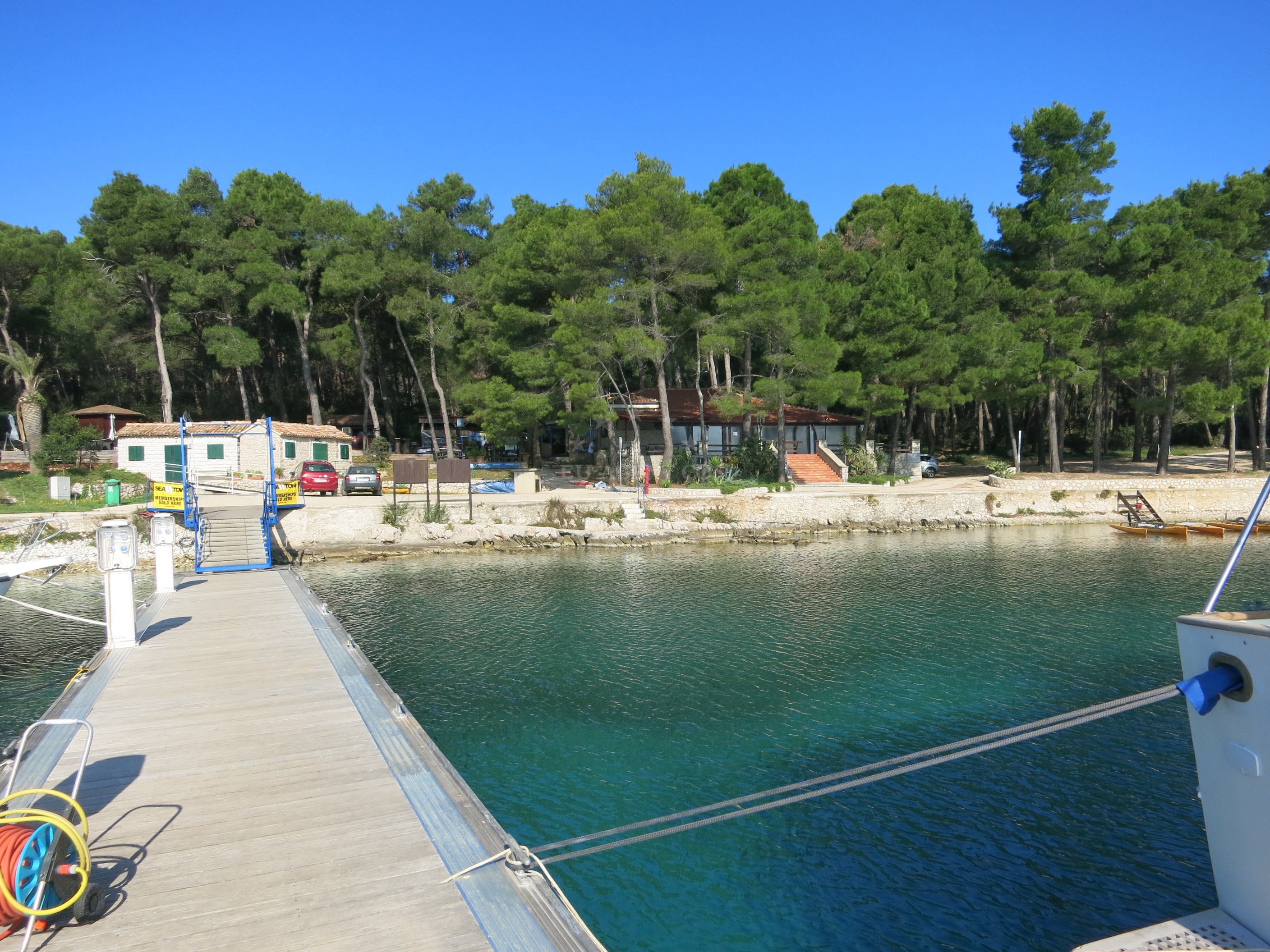 View of Mali Losinj jetty from the water with surrounding coastline