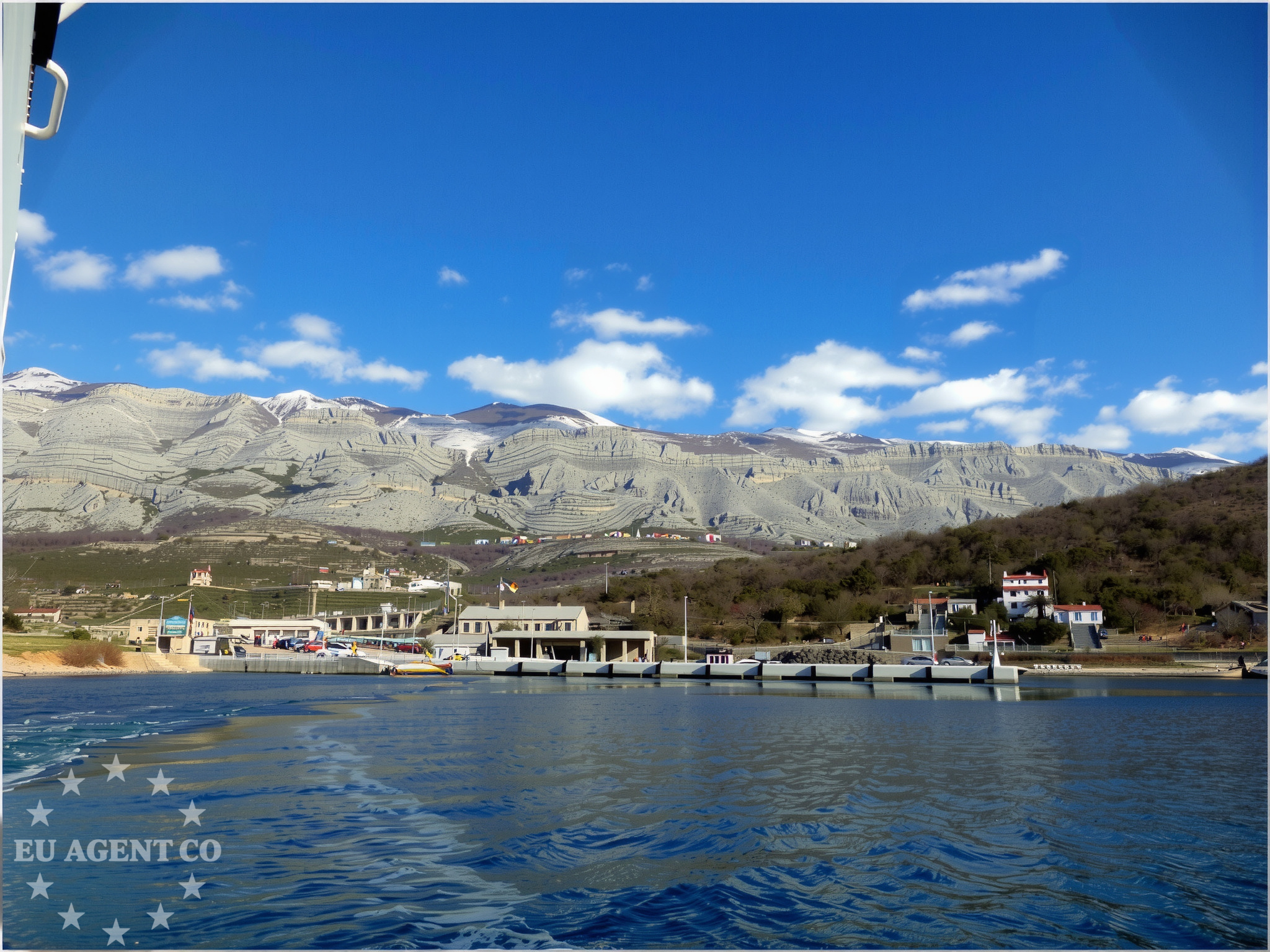 Nautical view of Stinica quay with boats and distant coastal landmarks