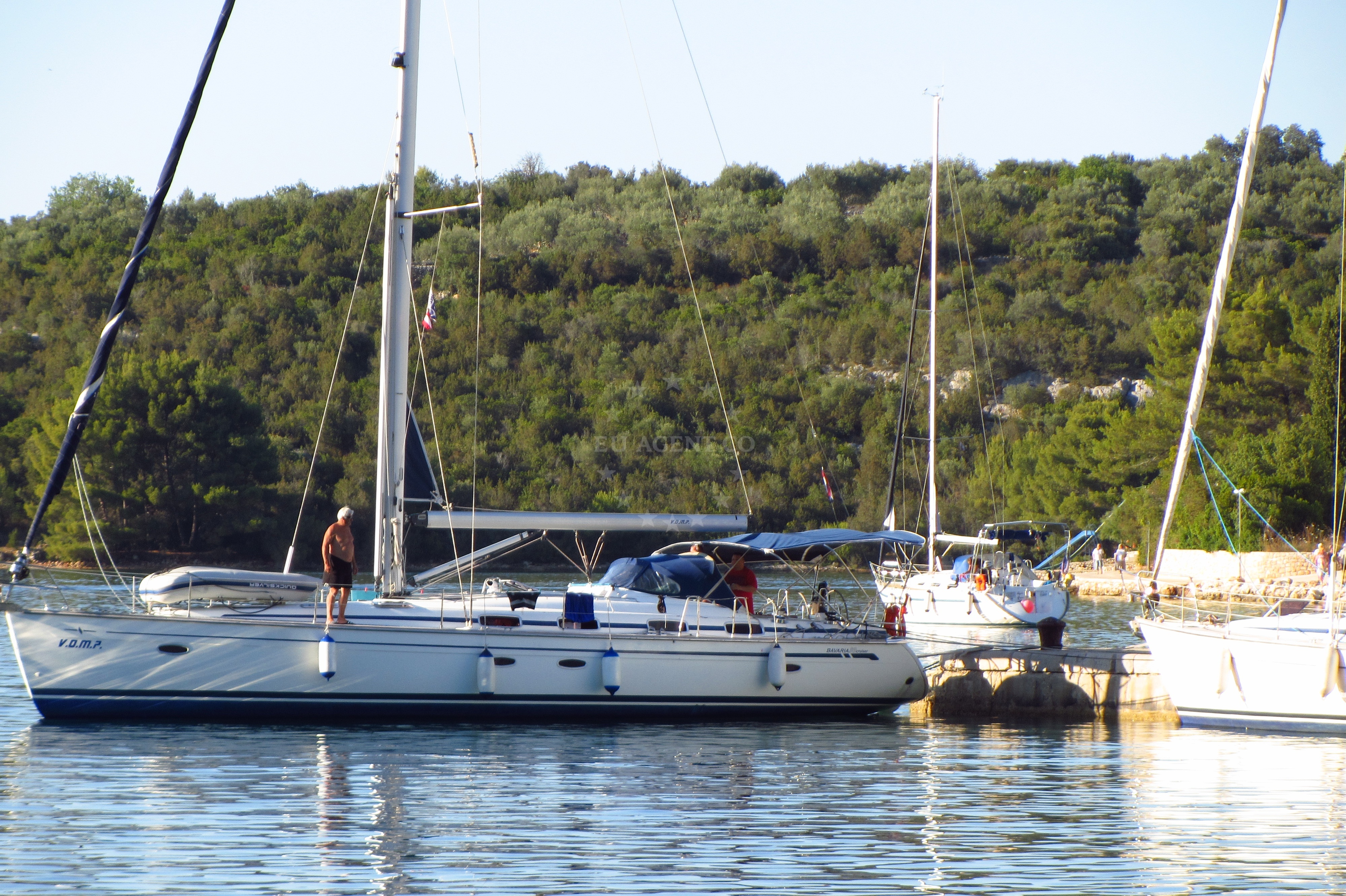Tranquil waters of Luka Quay with distant islands visible