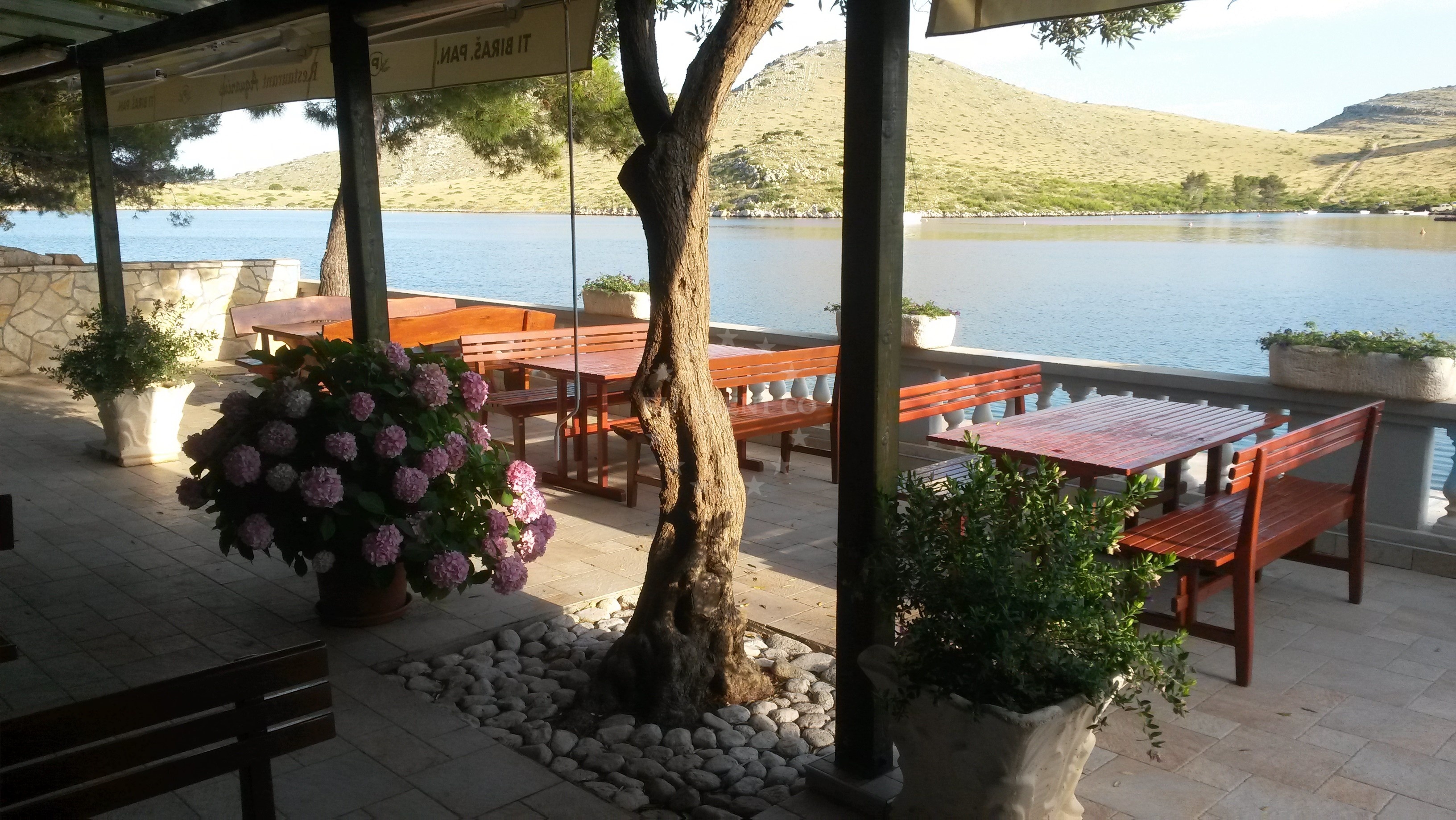 View of the Restaurant Aquarius Pier jetty with boats moored nearby