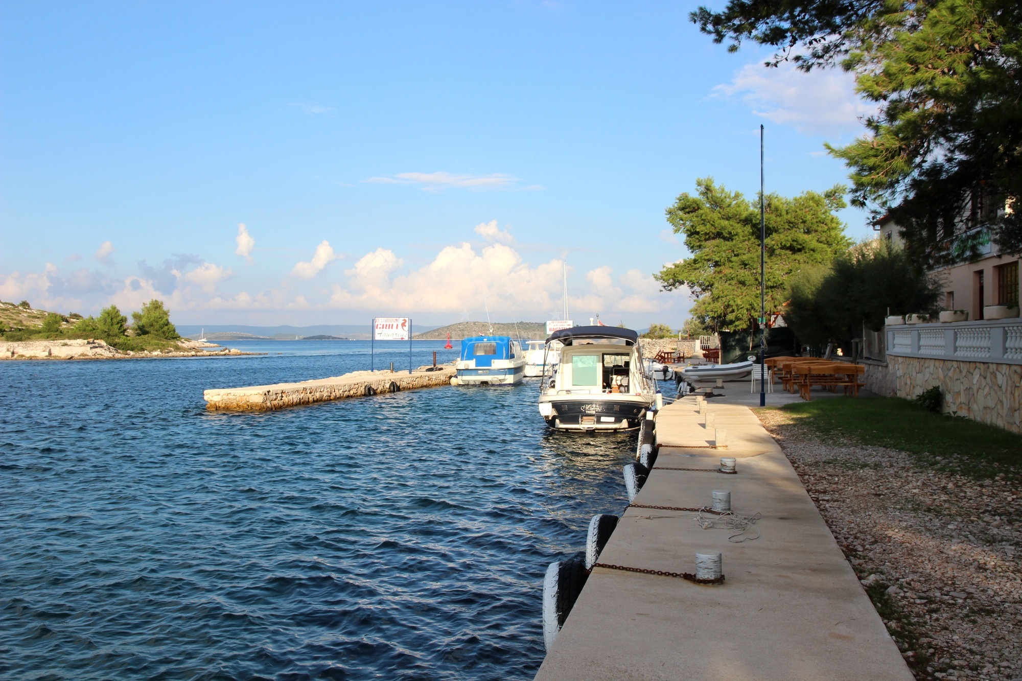 Boat moored at Restaurant Aquarius Pier jetty, Katina