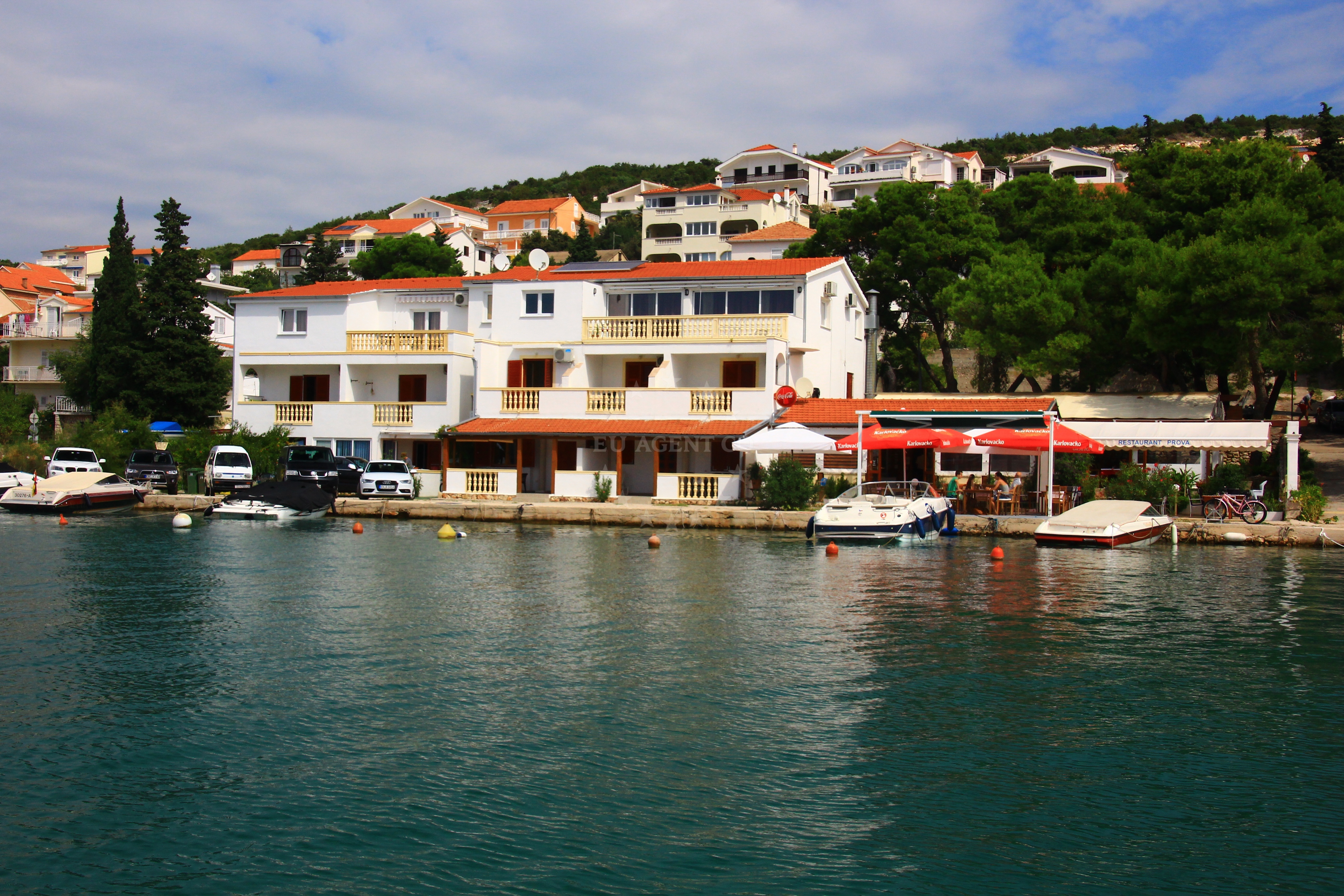 Motorboat berths at Prova Restaurant jetty in Tisno, North Dalmatia, Croatia