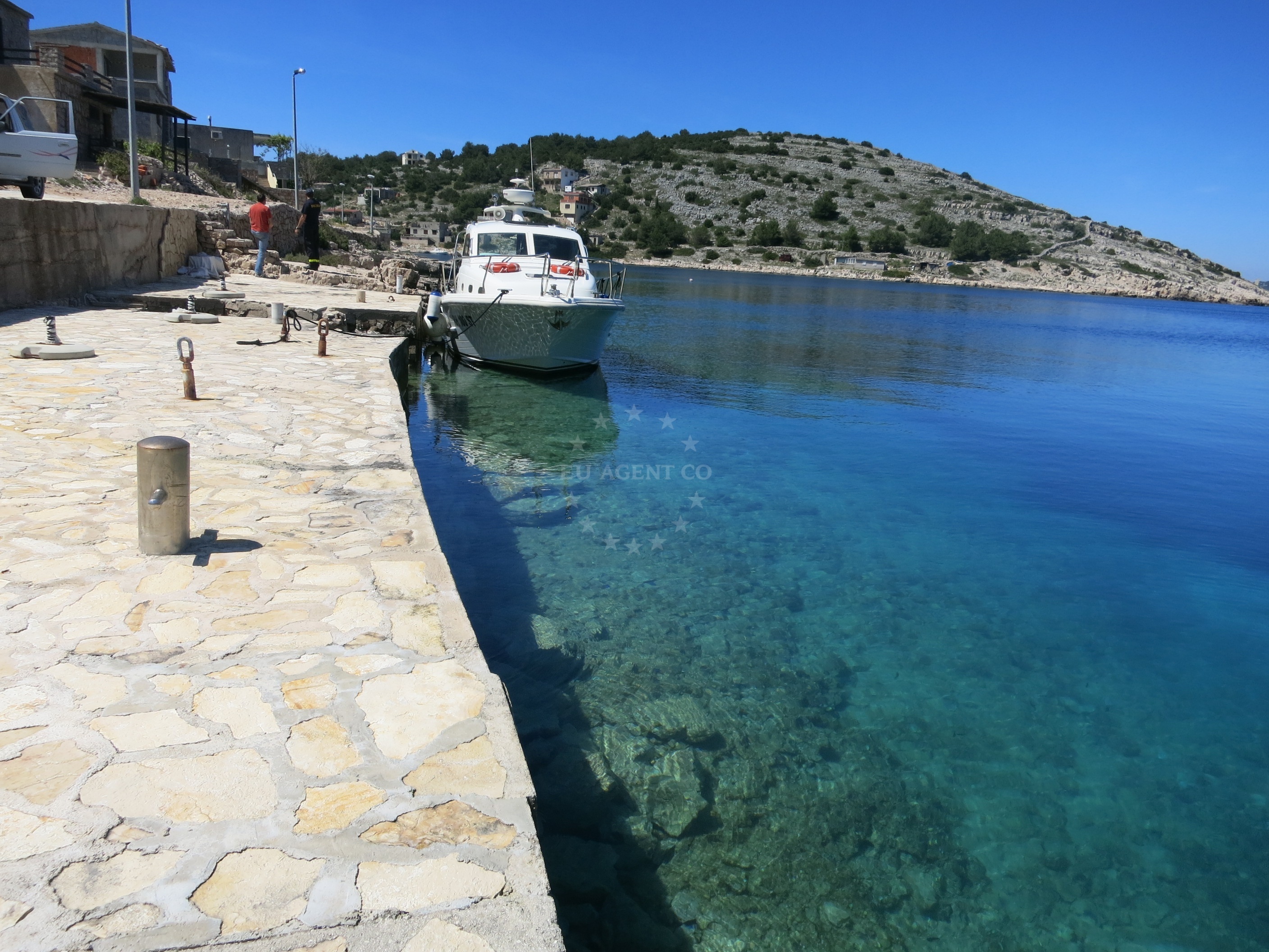 Quay in Zirje, North Dalmatia, Croatia with nearby stones and mooring lines