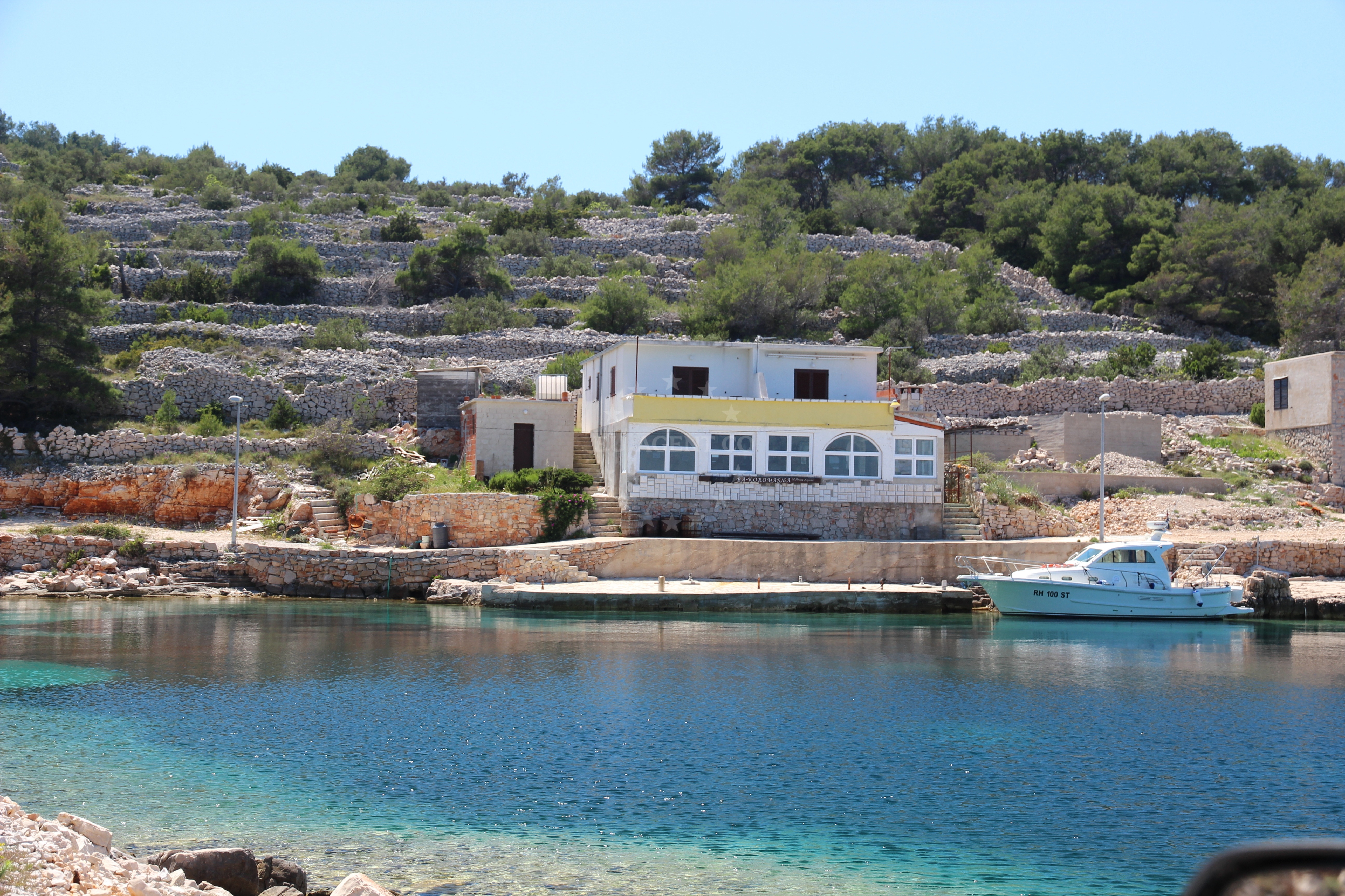 Sailboat approaching the quay in Zirje, North Dalmatia