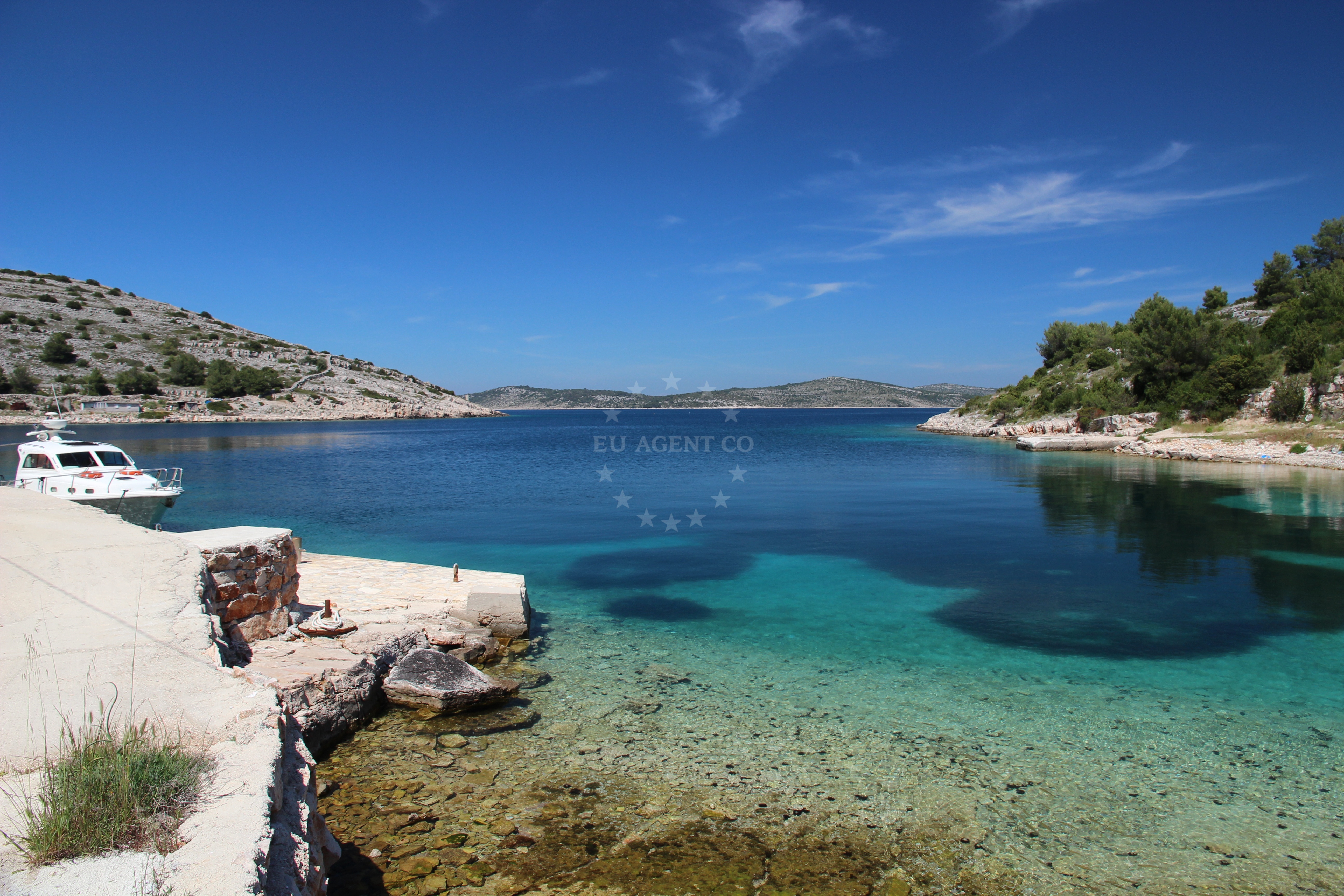 View of the quay in Zirje with surrounding Adriatic Sea and nearby Konoba Koromasna