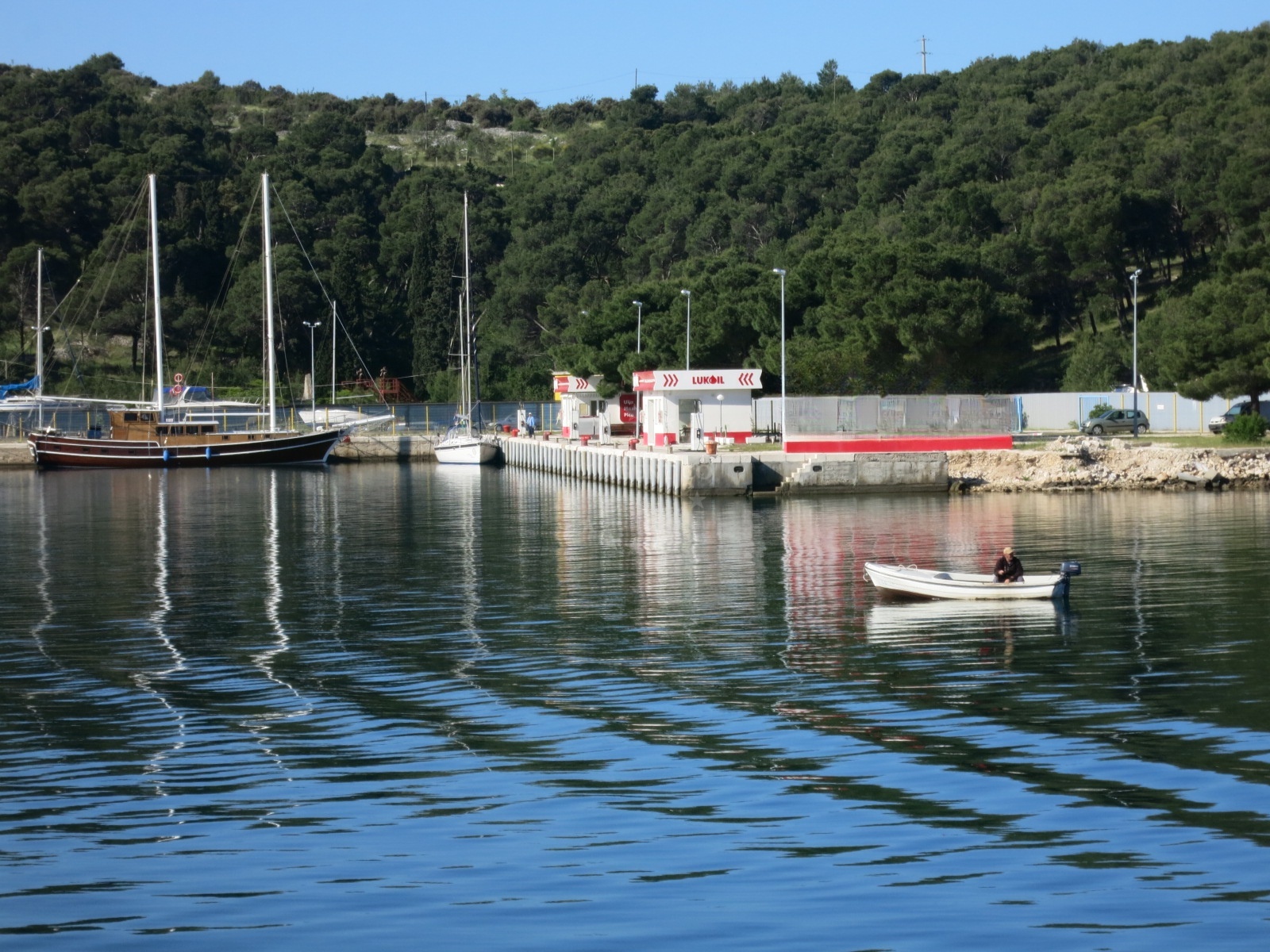 Lukoil fuel station in Šibenik, Central Dalmatia, Croatia with marina Mandalina in the background