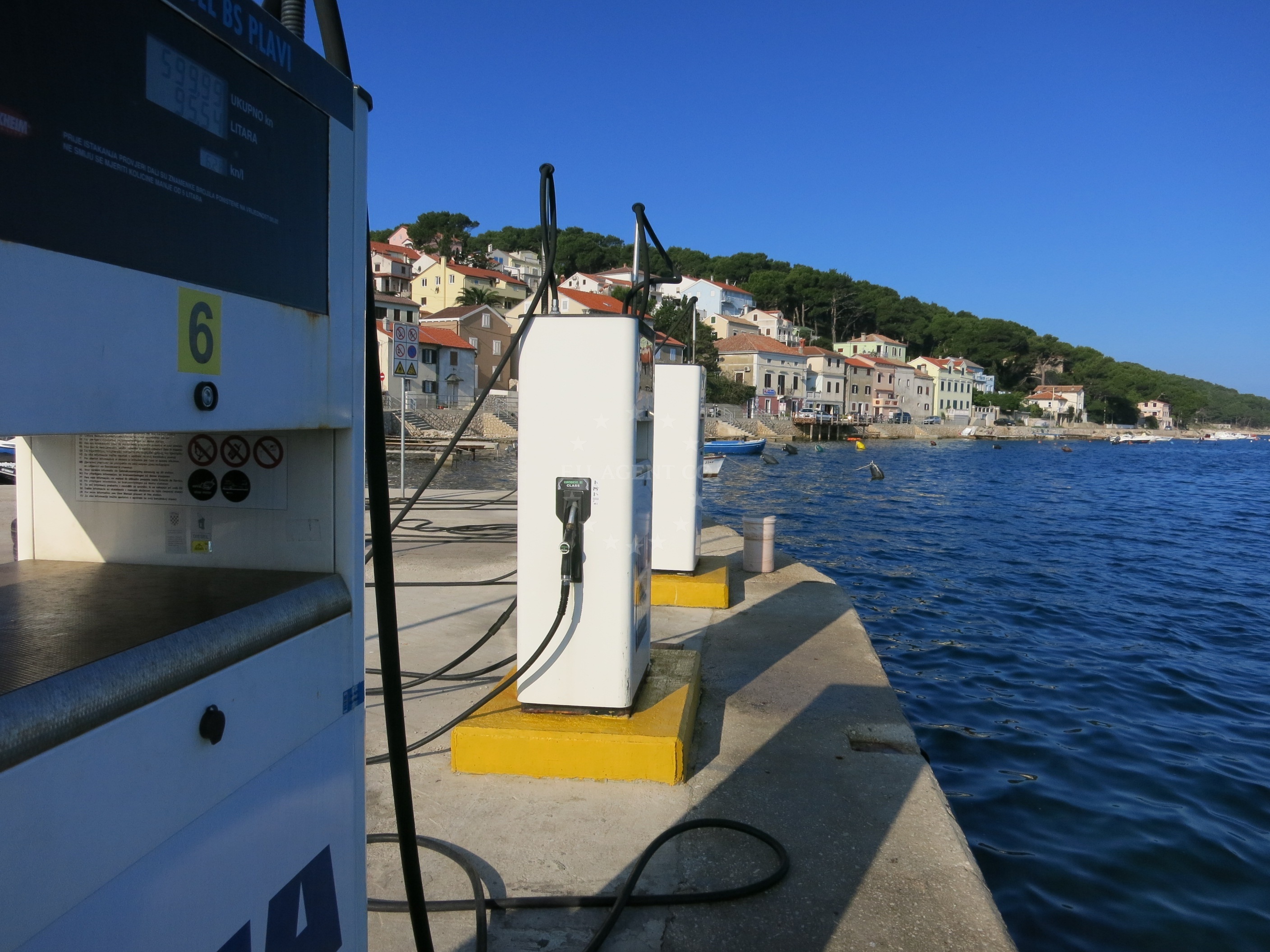 Ina Fuel Station in Mali Lošinj, Croatia with petrol pumps and Adriatic coastline view