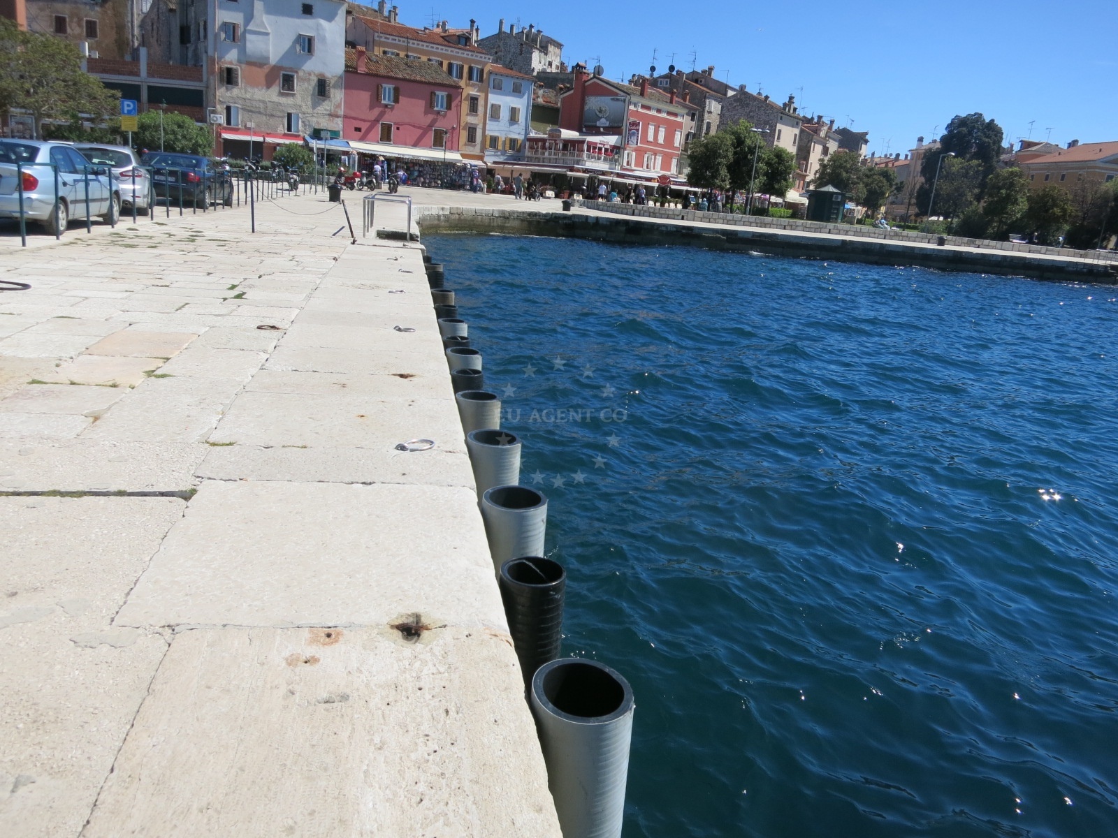 Fuel pumps at Ina station, Rovinj, Croatia with nearby quay