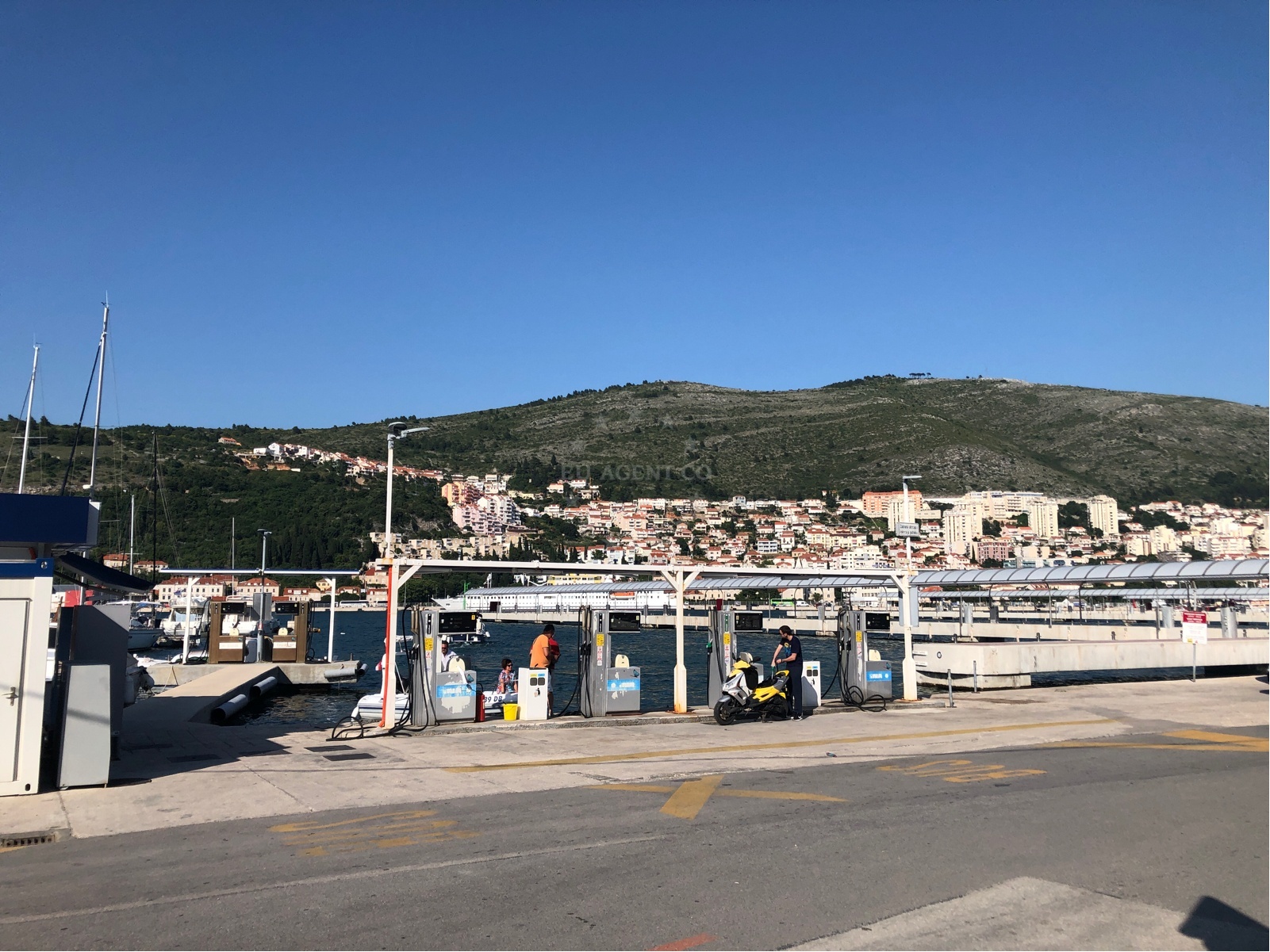 Fuel station signage and nautical charts displayed at Ina