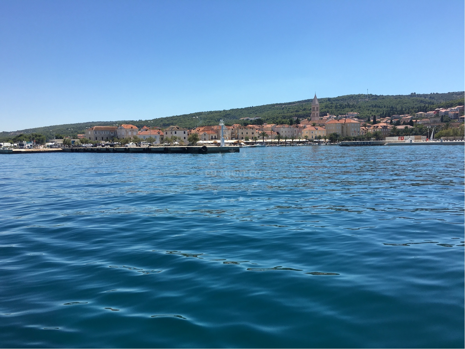 Supetar Harbour with nearby restaurants and cafes visible on the shore