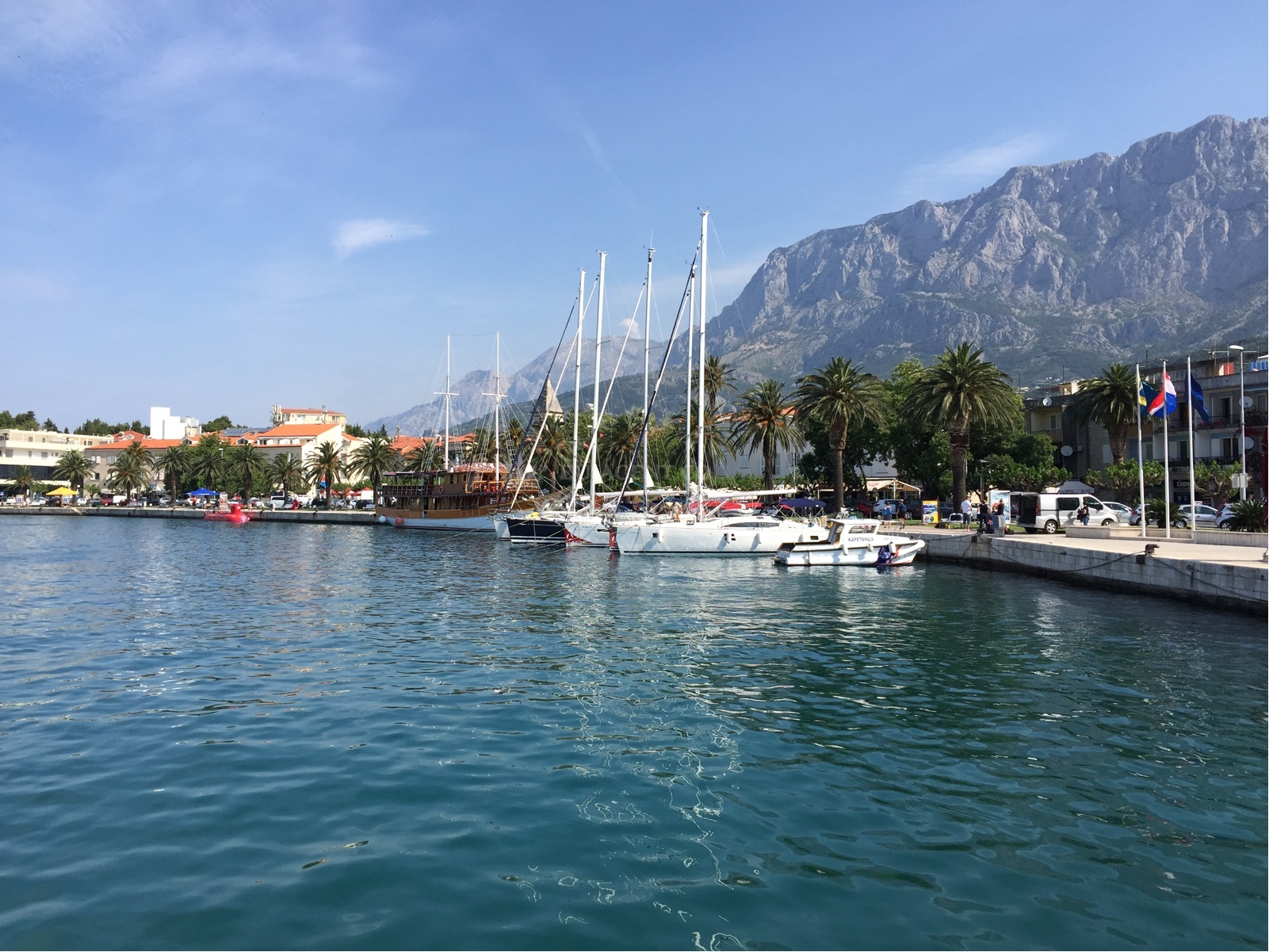 Sunset view over Makarska Harbour with boats on the water
